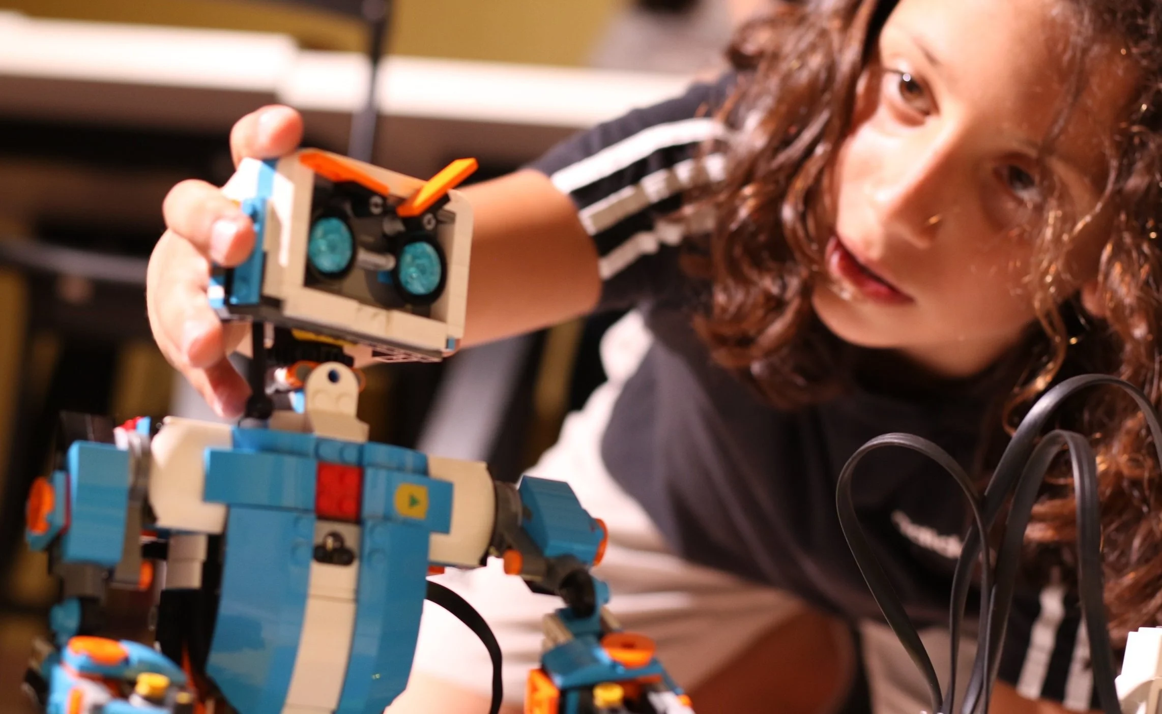 Student testing a LEGO robot for a robotics competition