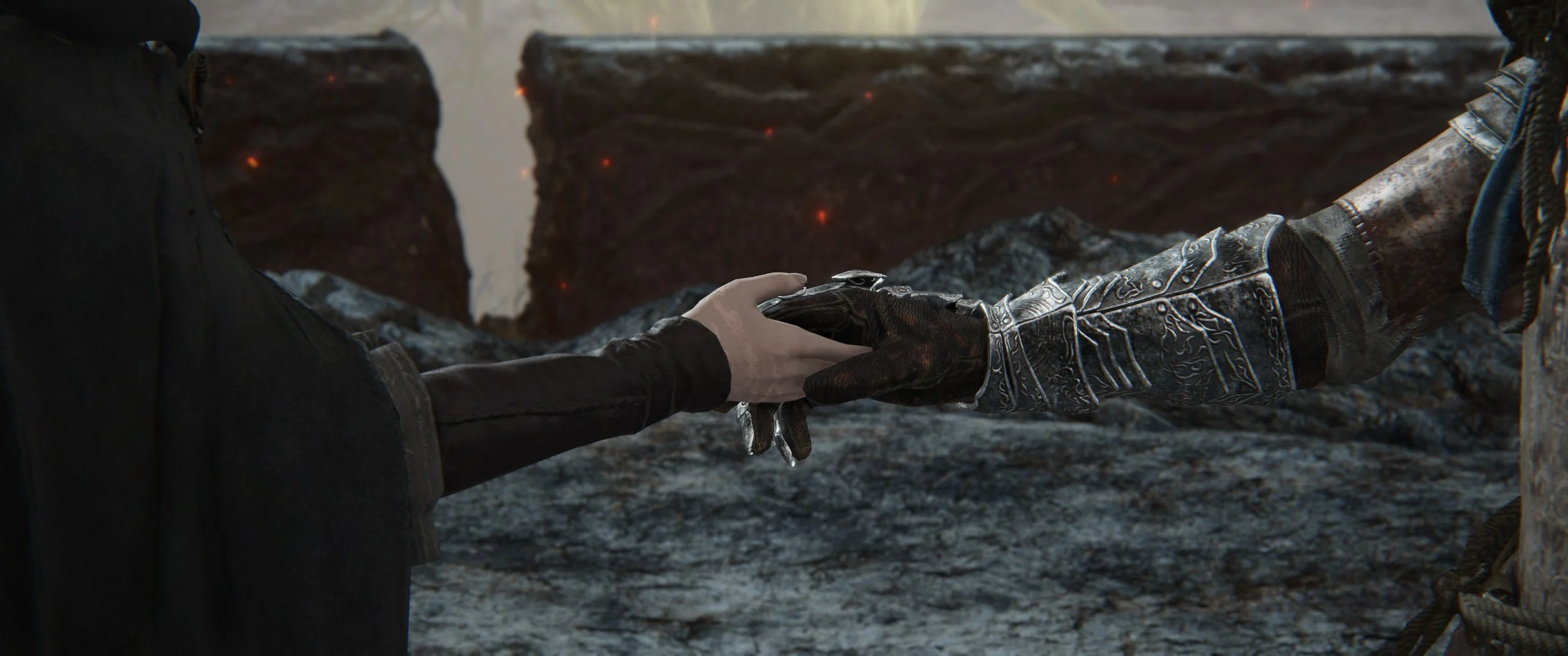 Eine Nahaufnahme von zwei Händen, die sich berühren, mit einer dramatischen Hintergrundszene aus Lava und dunklem Gestein.