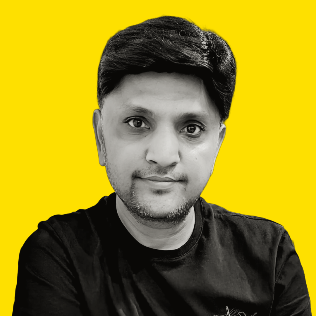 Black and white portrait of a man with short hair, wearing a black T-shirt, against a bright yellow background.