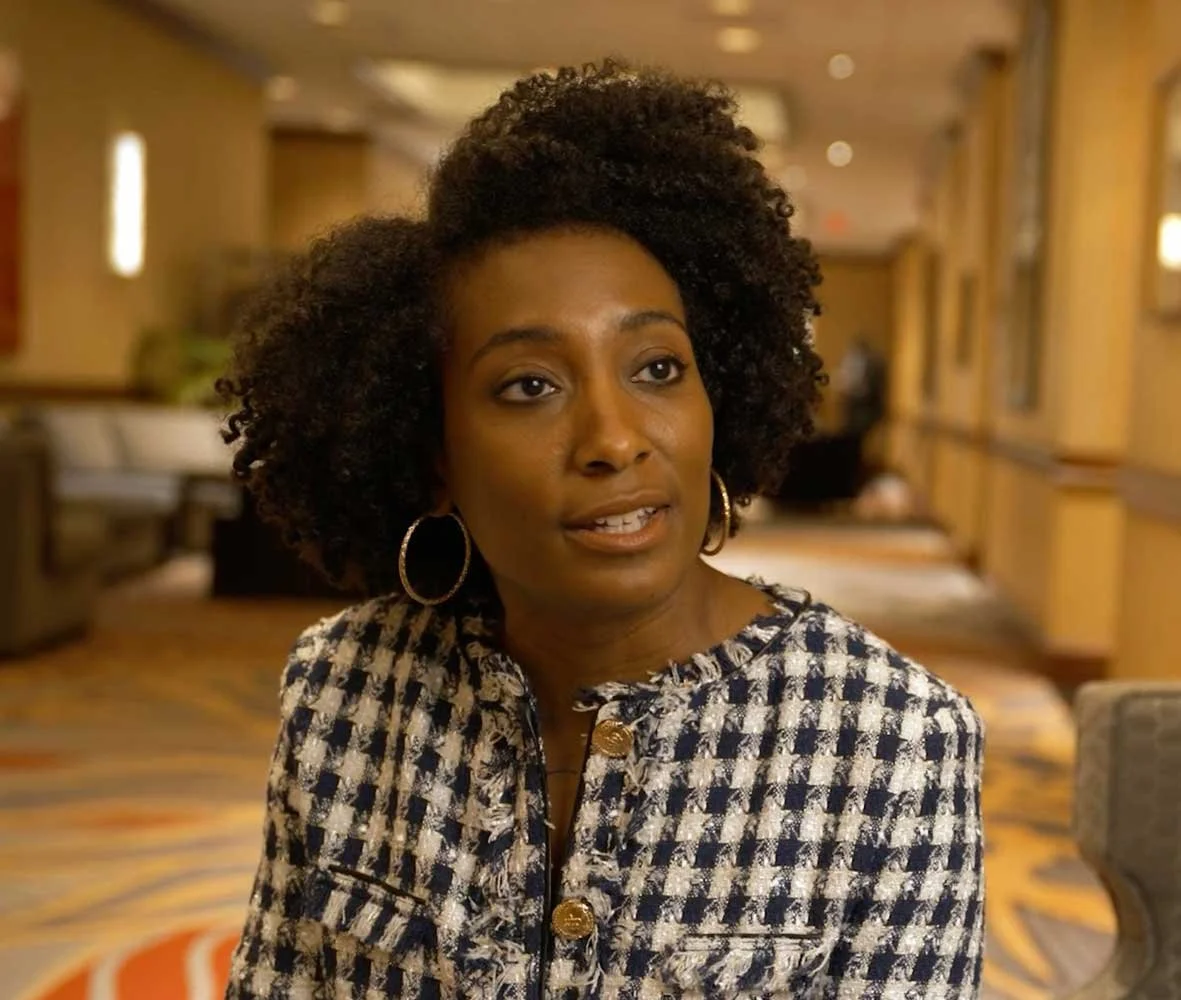 Professionally dressed woman in a conversation.