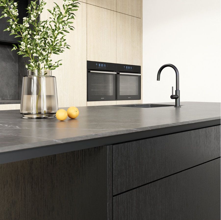 kitchen with dark cabinetry, porcelain benchtop and modern appliances