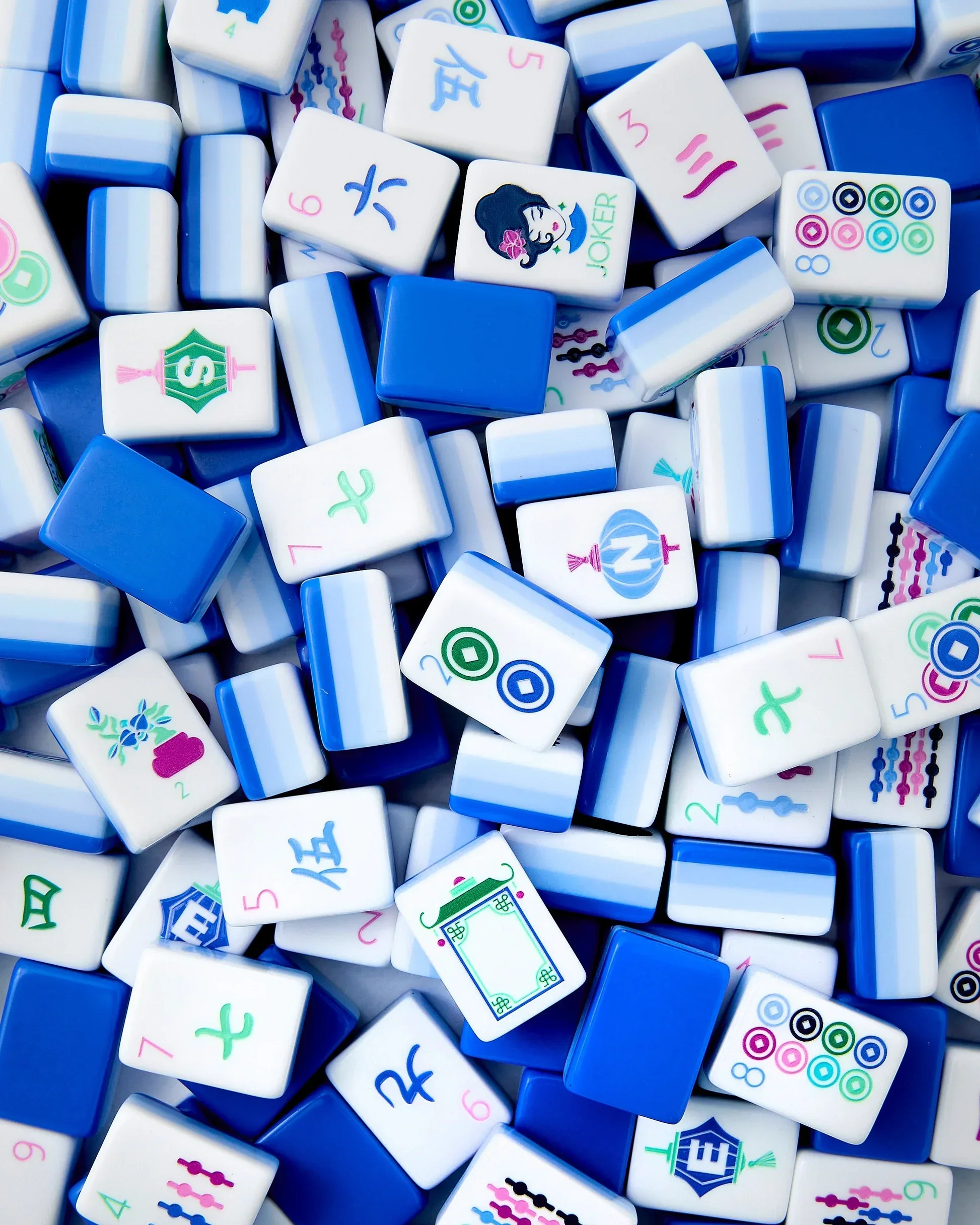 Close-up of colorful mahjong tiles with various patterns and designs.