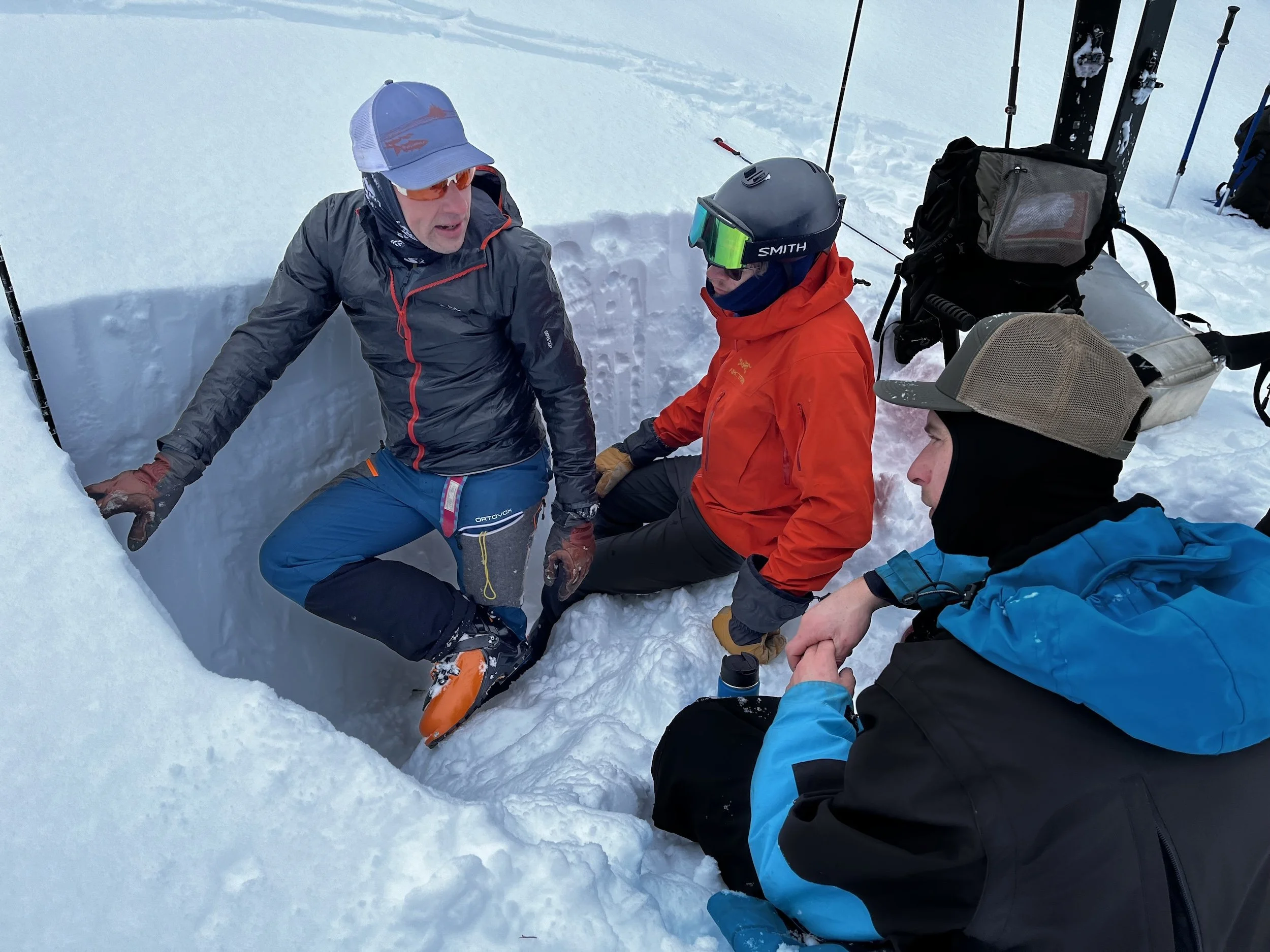 Avalanche Skills Training (AST2) instructor Sean Fraser explains layers in a snow pit.