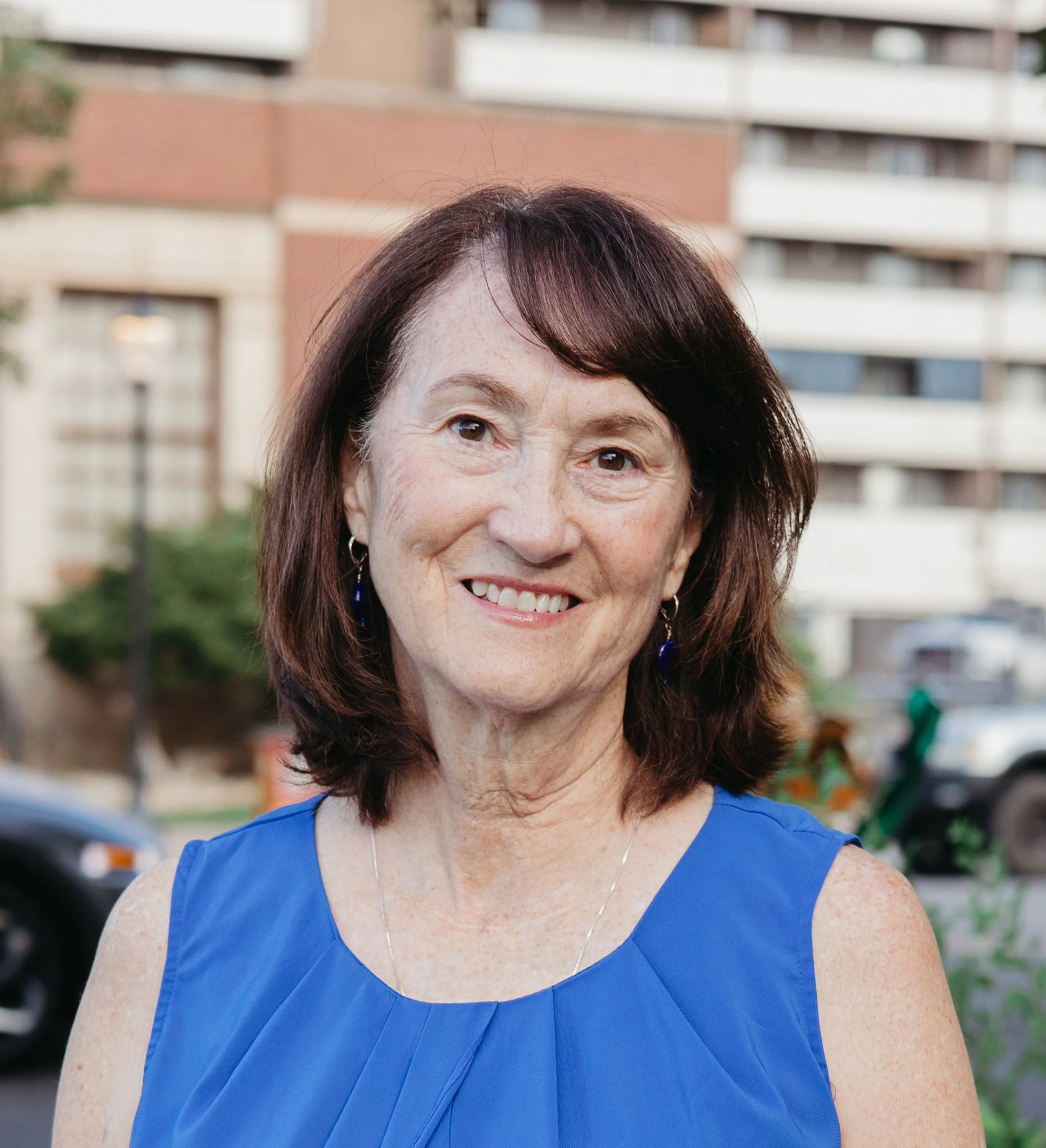 Headshot of Linda Olson smiling at the camera outside CAFE 180