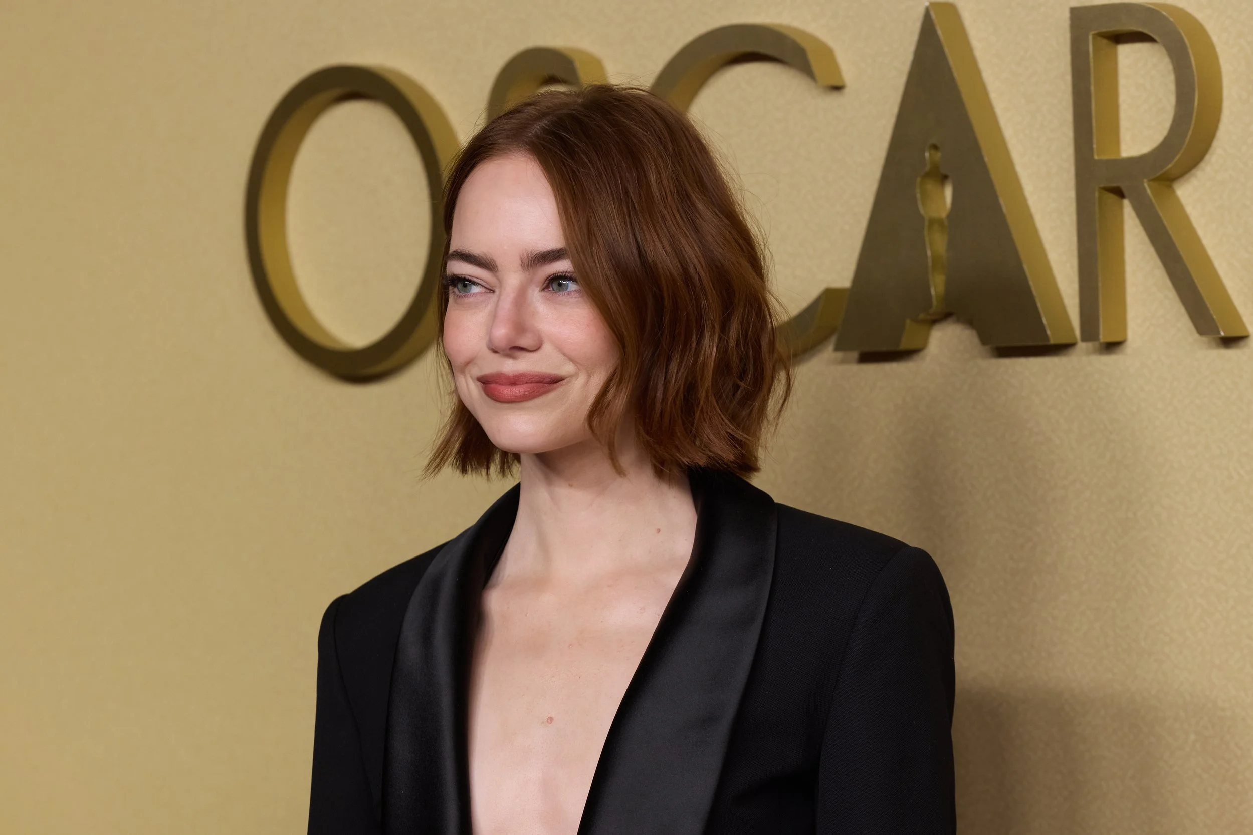 Emma Stone in a black Julie de Libran blazer dress at the 98th Oscars Nominees Luncheon at The Beverly Hilton.