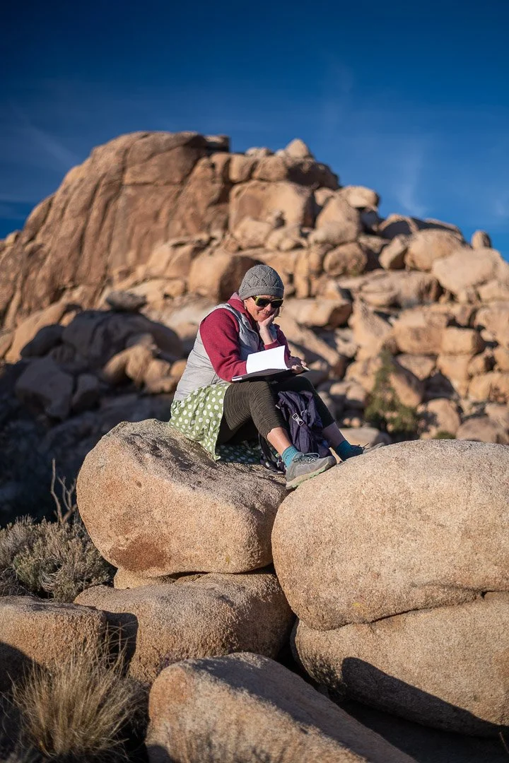 Jes journals on a boulder in Joshua Tree.