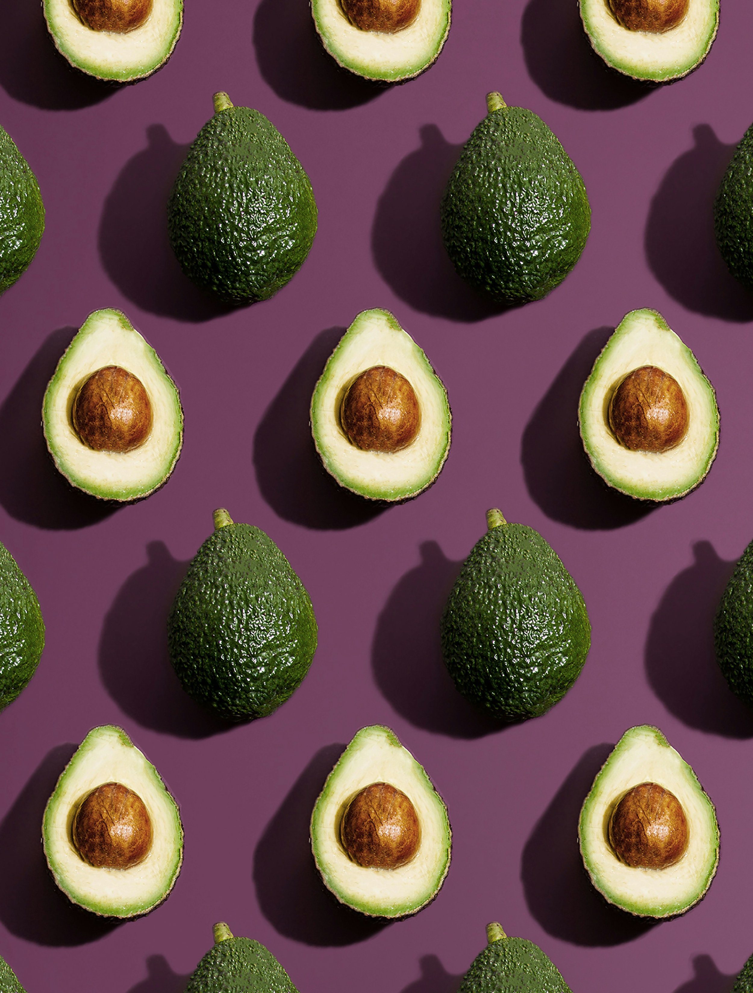 Avocados on a purple background.
