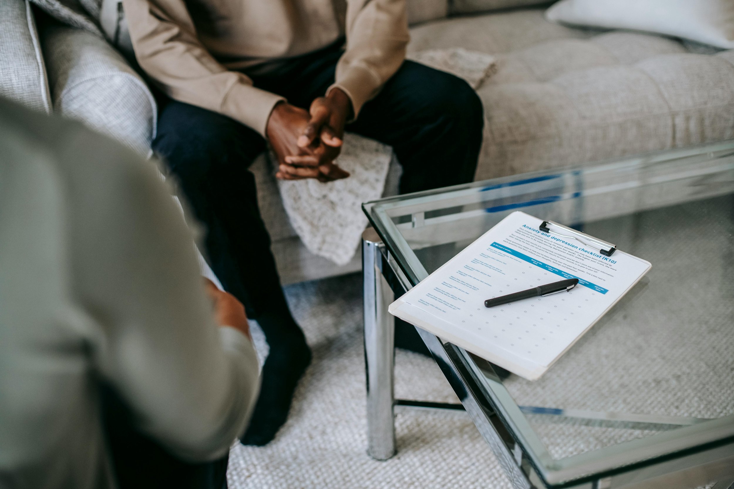 A therapist and client engage in a calm, supportive conversation in a safe and welcoming environment, focused on emotional understanding, healing, and personal growth.