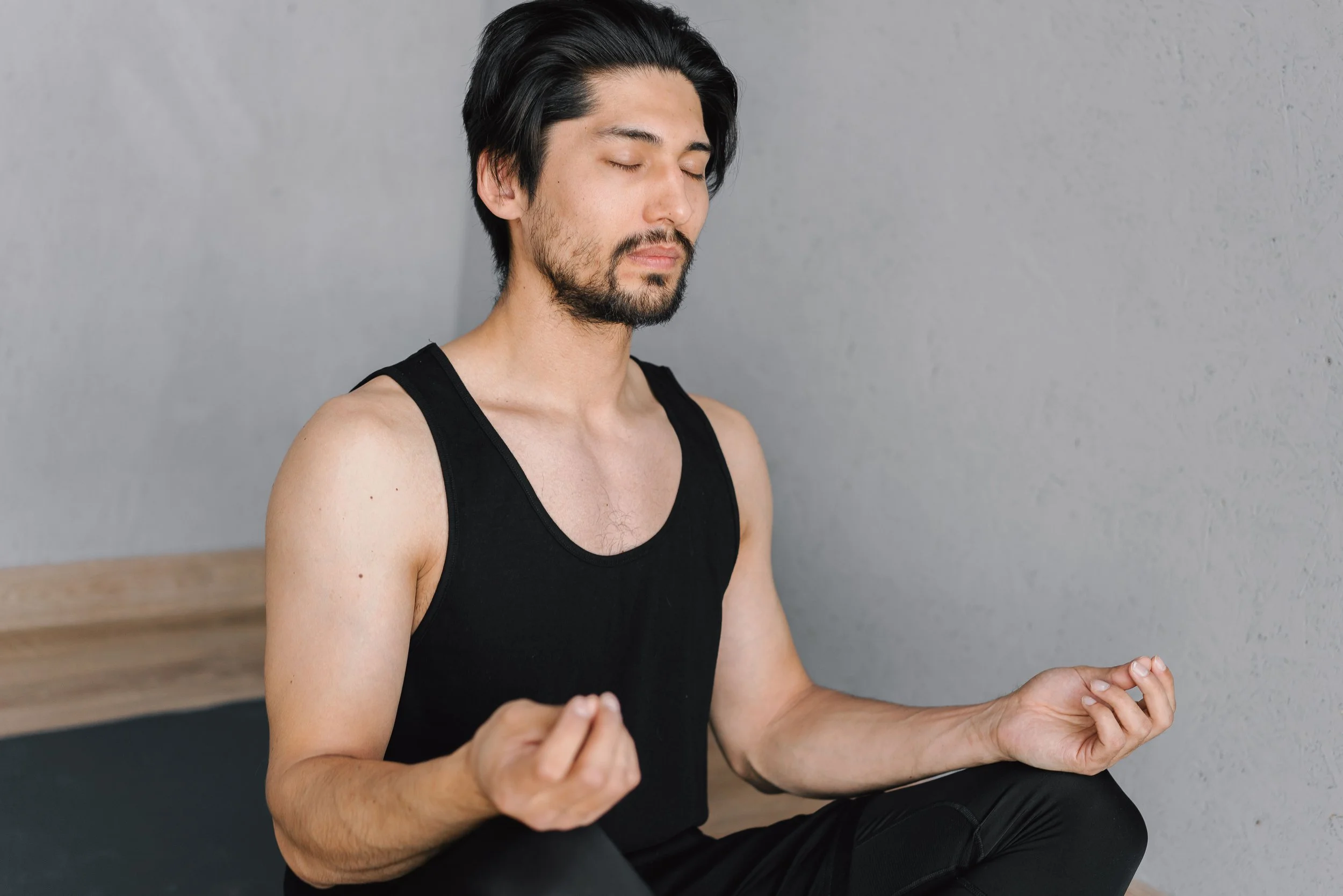 A person is calmly practicing mindfulness and self-awareness in a quiet setting, focusing on breathing, presence, and inner balance for emotional well-being and mental clarity.