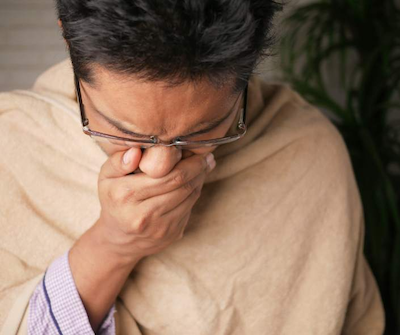 Man sneezing from poor indoor air quality
