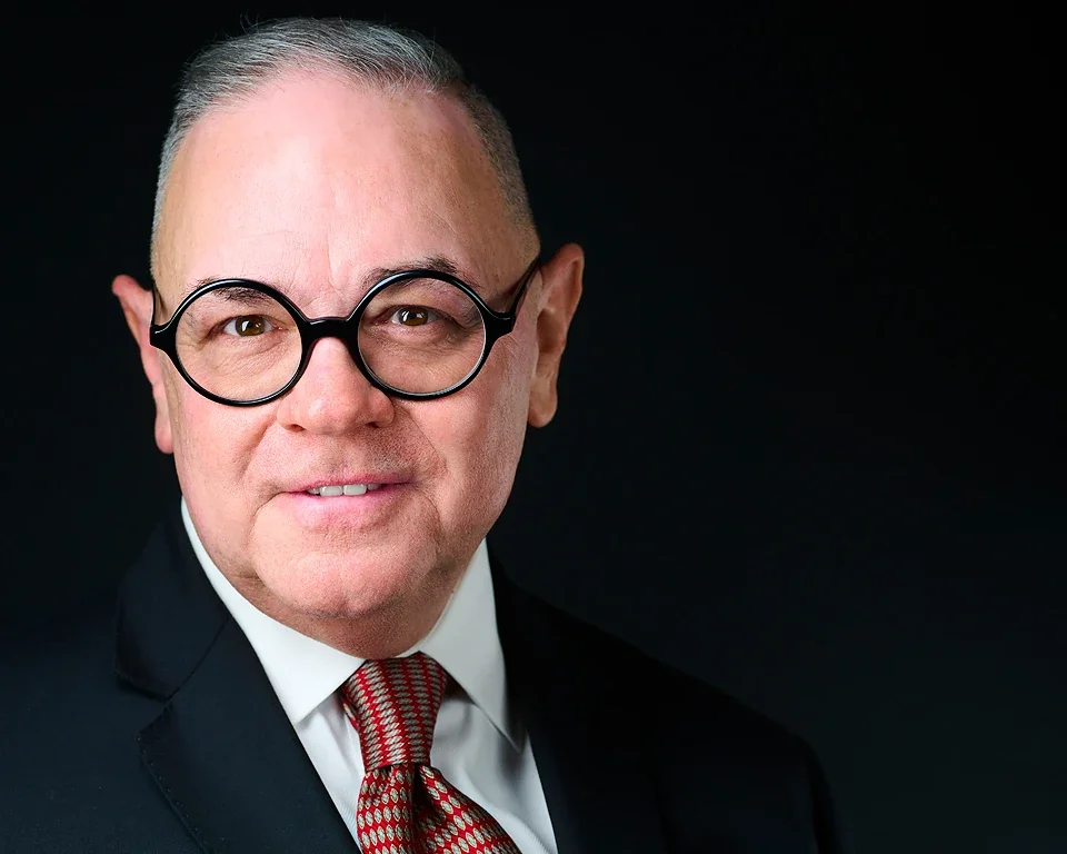 Executive headshot of a man in glasses and red tie by Pandorica Headshot Studio Las Vegas
