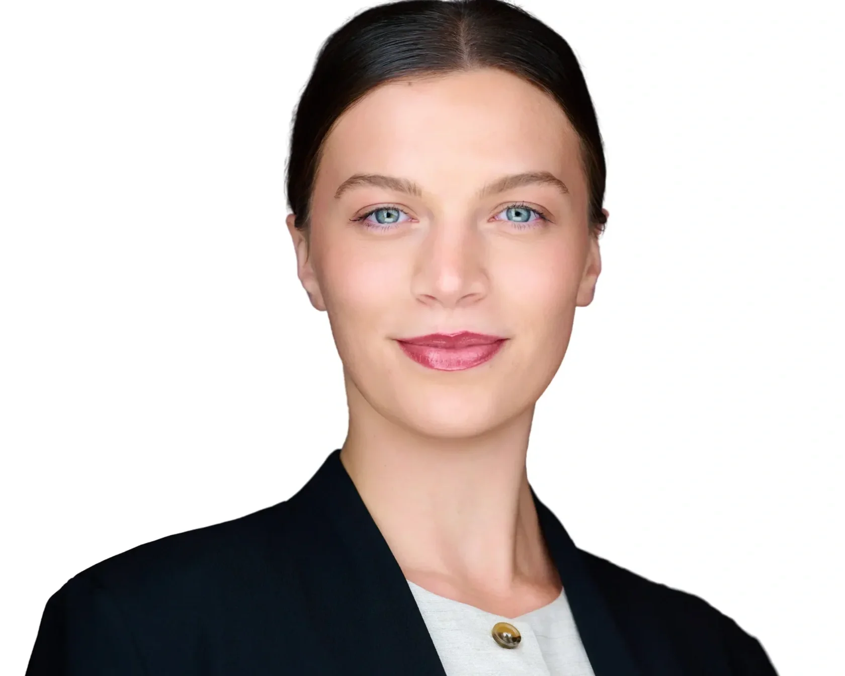 A woman with fair skin, straight dark hair, blue eyes, and pink lipstick, wearing a black blazer over a white top with a gold button, smiling against a plain white background.