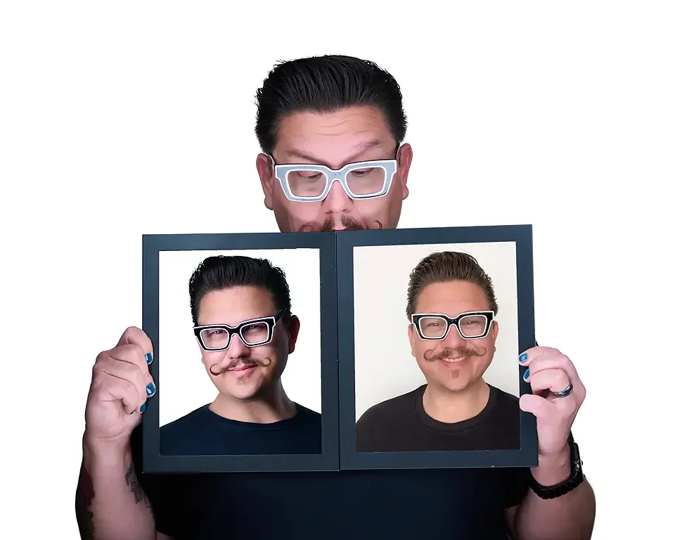 male holding two picture frames, one with a professional headshot and the other is a selfie