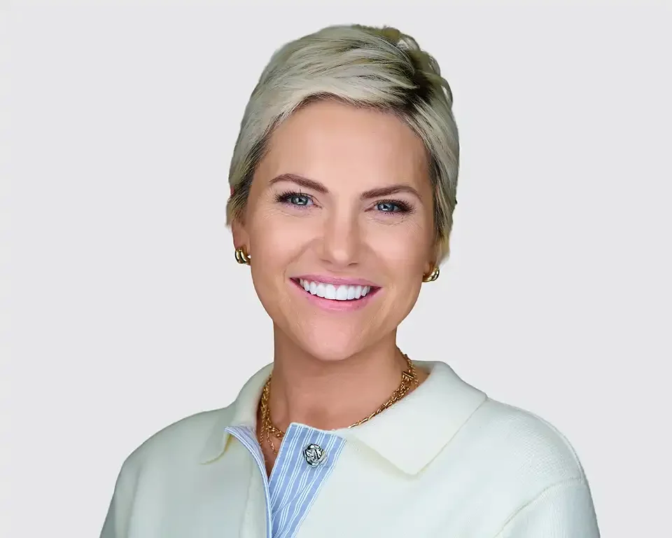 Professional headshot of a woman with short blonde hair wearing a white blazer and gold necklace, photographed at Resorts World Las Vegas during ThriveLIVE 2026 by Pandorica Headshot Studio