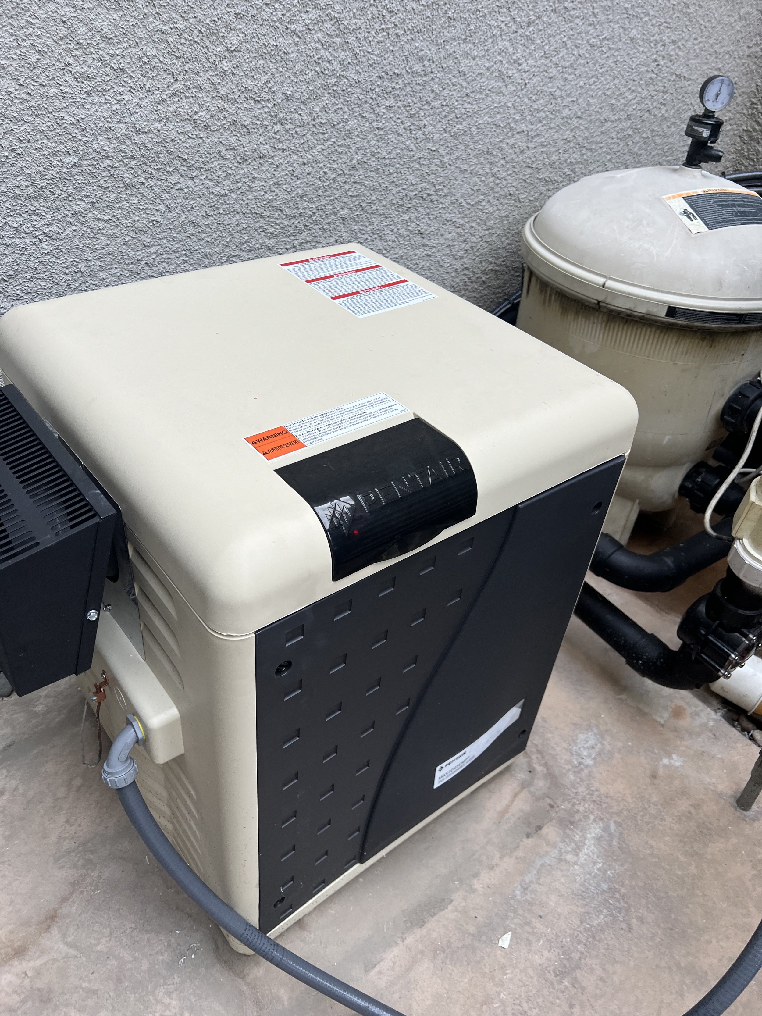 Pool heater and filter system on concrete surface