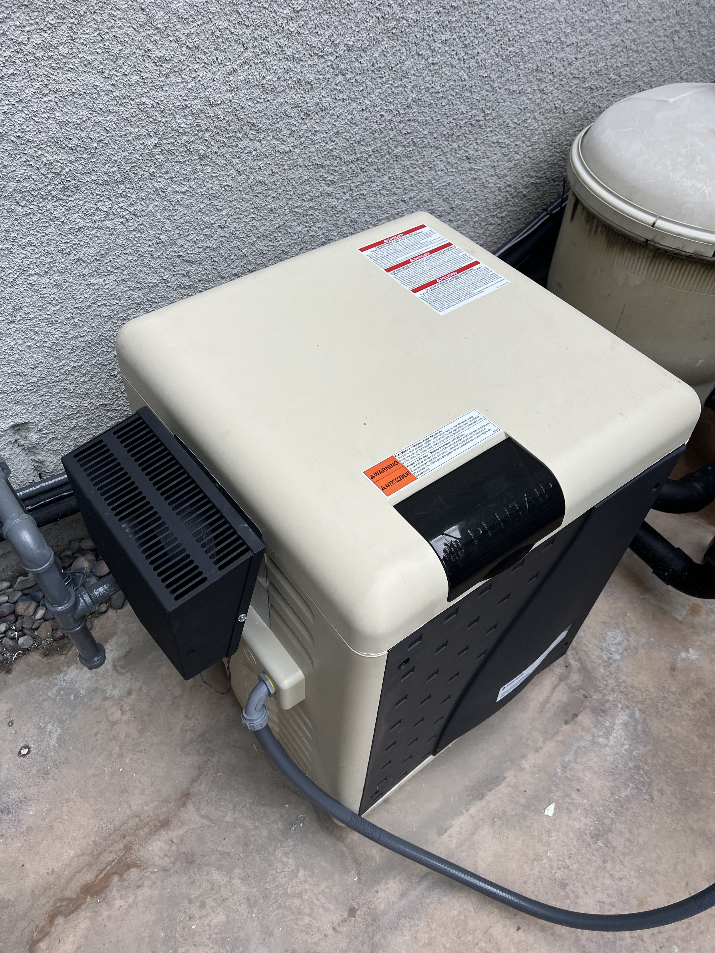 Pool heater unit with labeled warnings