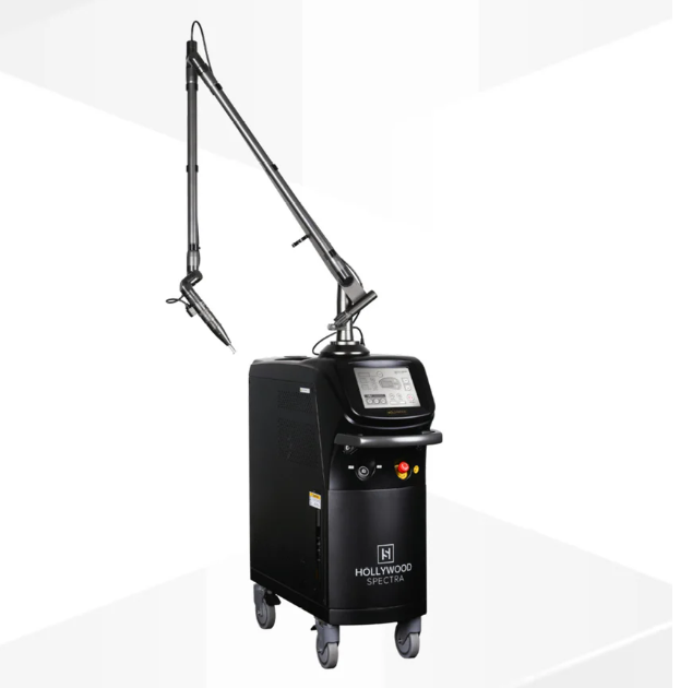 Medical laser device labeled Hollywood Spectra with a flexible arm and handpiece, on wheels in a clinical setting.
