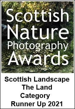 A poster for the Scottish Nature Photography Awards 2021, featuring a lush green landscape with trees and foliage, with text announcing the Scottish Landscape Land Category Runner Up 2021.