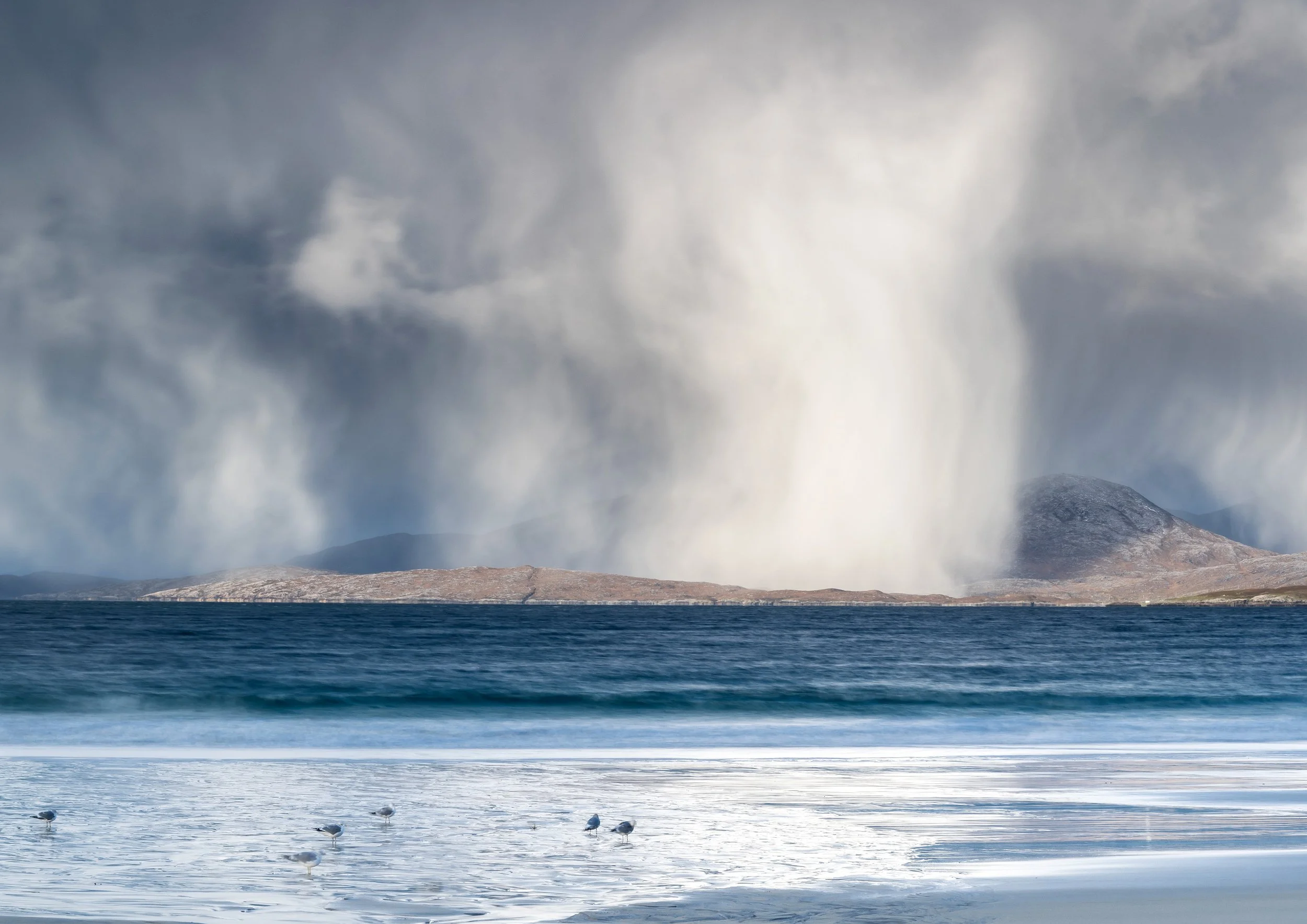Luskentyre Beach during a winter storm.Isle of Harris Outer Hebrides Scotland Seascape Photography. Sea & Coast Category winner of the Scottish Nature Photography Awards. Luskentyre Beach, Isle of Harris in winter. Snow showers falling over 