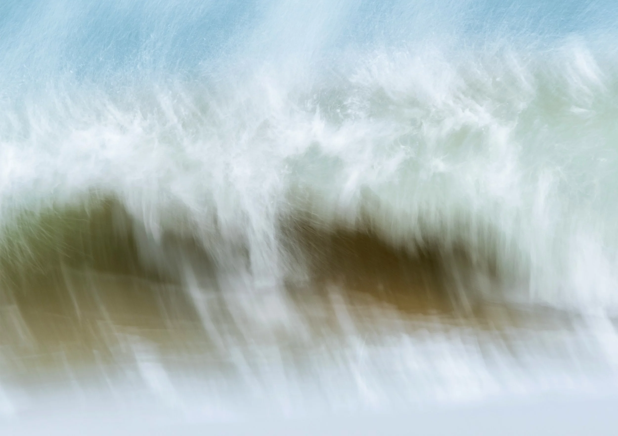 Close-up of crashing ocean waves creating white foam and spray.