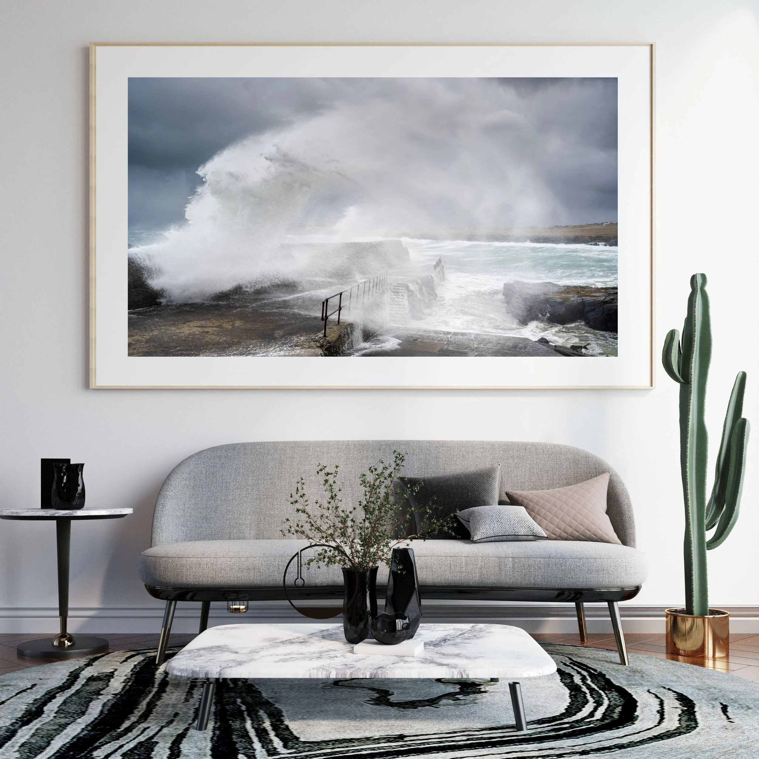 Framed print of a storm‑driven Atlantic wave hitting the harbour wall at Port of Ness on the Isle of Lewis, displayed on a wall