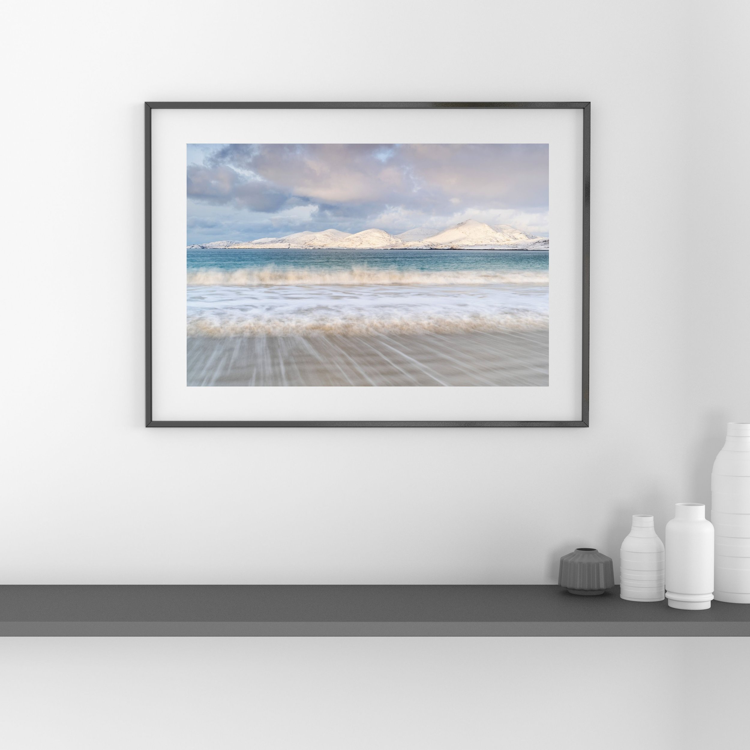Framed print of Luskentyre Beach on the Isle of Harris, showing winter light and snow‑capped mountains.