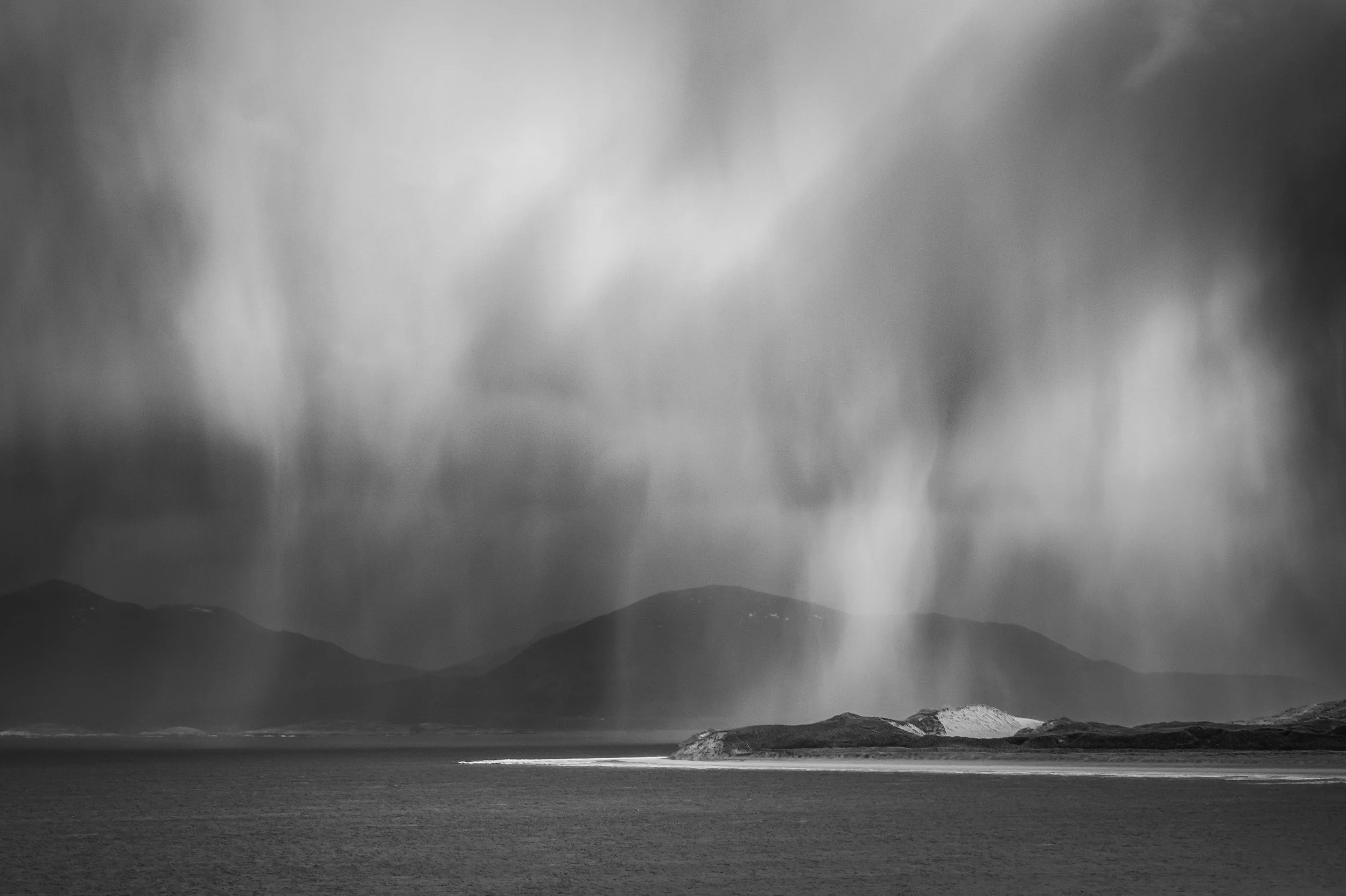 Isle of Harris landscape photography during a winter storm, light and bands of rain falling from the sky