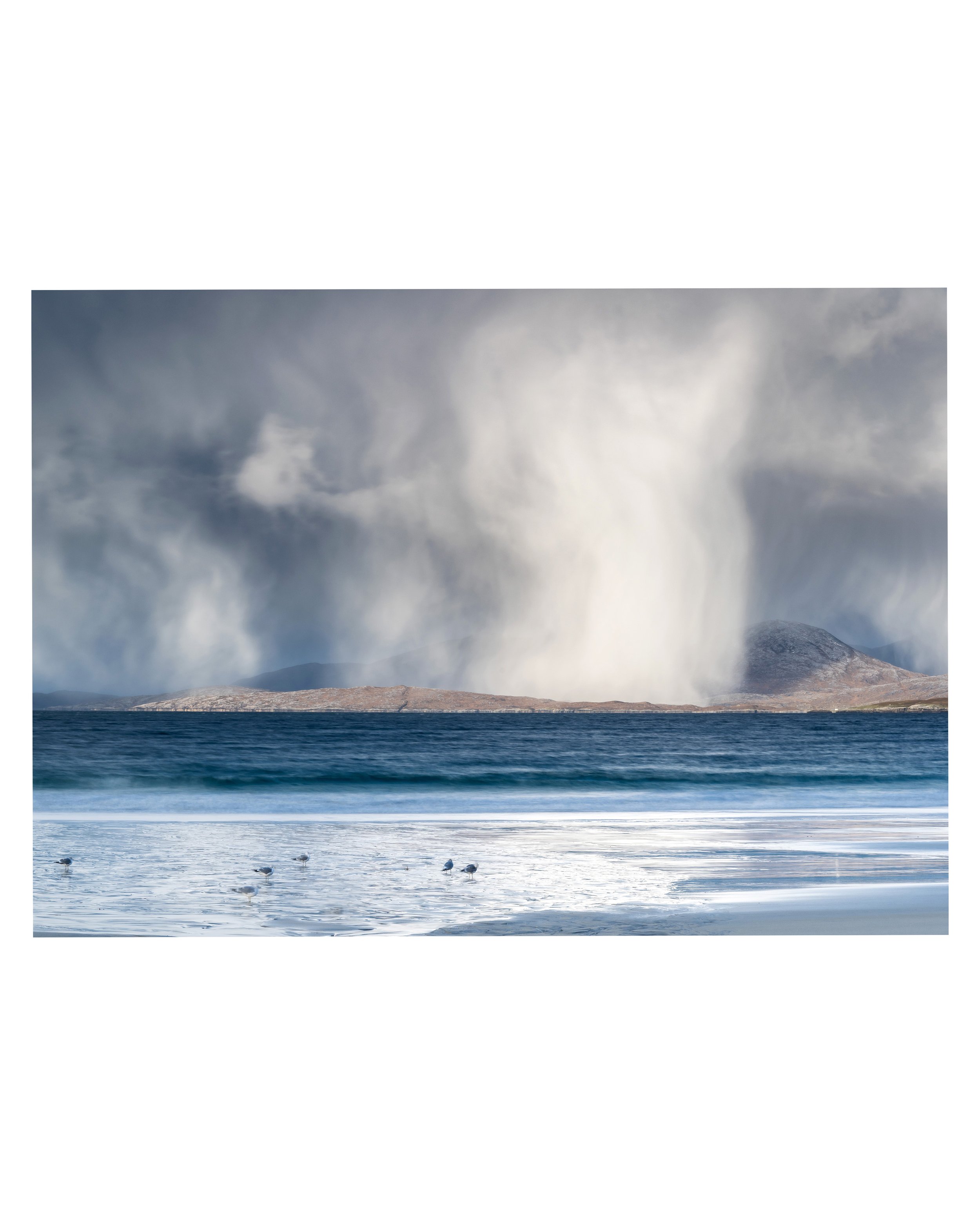 Luskentyre Beach under towering winter skies, with snowfall pouring from dark clouds and light breaking across the sand.