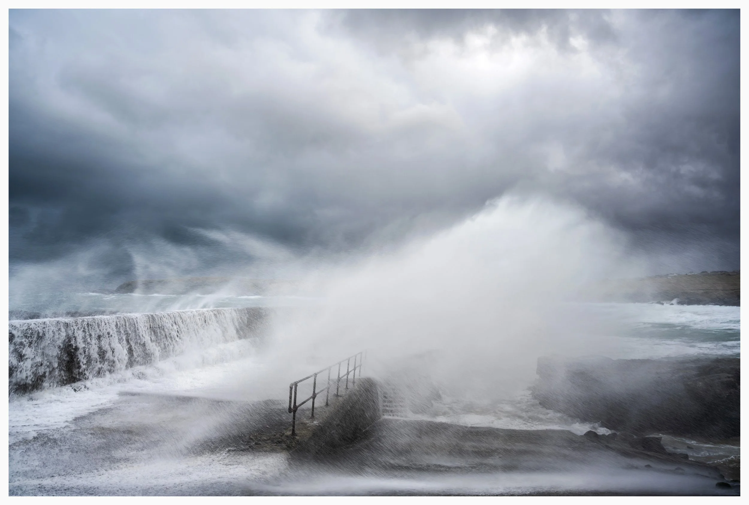 Port of Ness, Isle of Lewis. Outer Hebrides, Scotland. Storm waves crash against the harbour wall