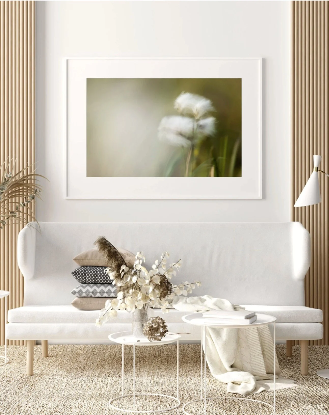 Framed print of “Cotton Breeze” displayed on a wall, showing soft white cotton grass moving in the breeze against blurred moorland tones.