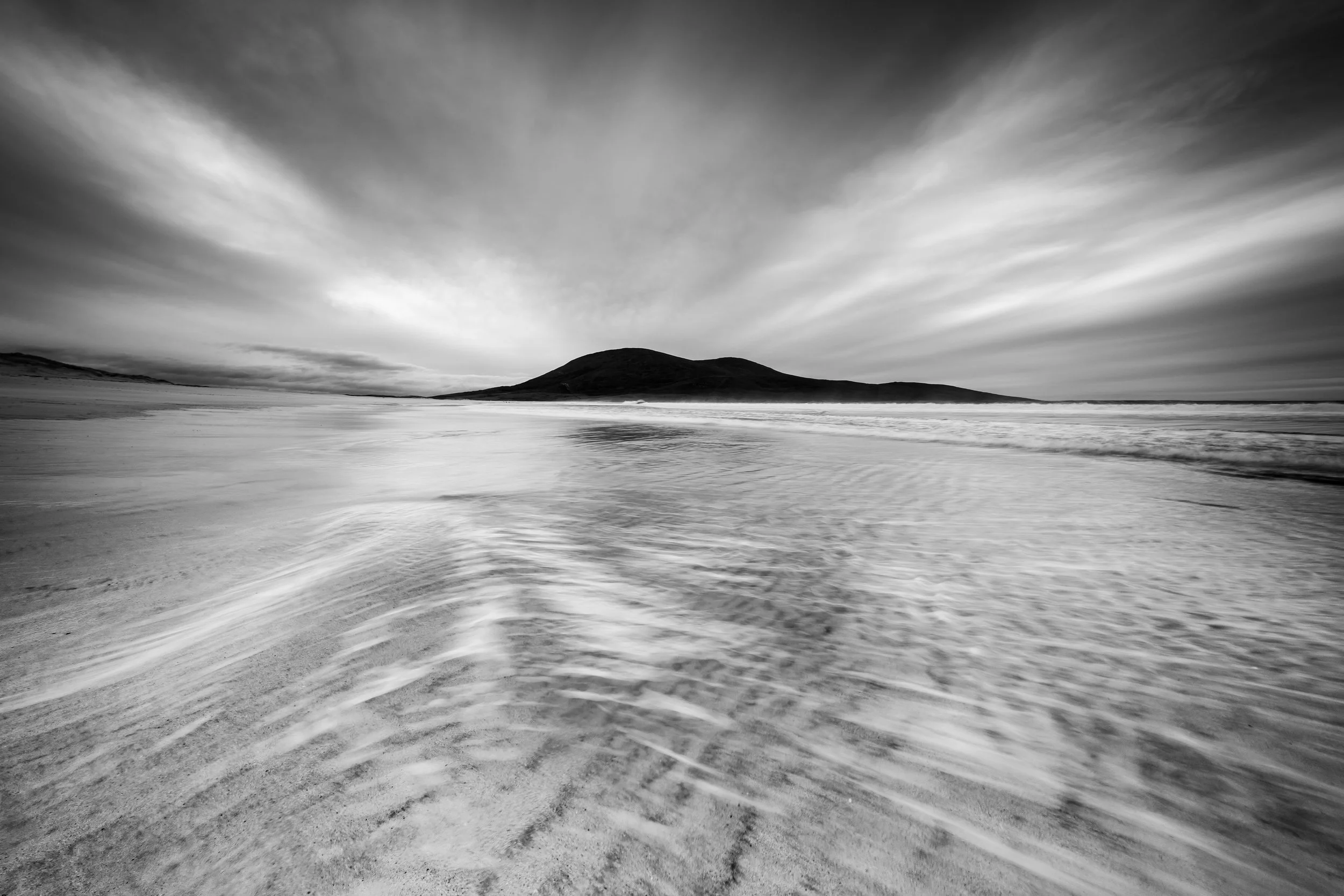 Scarista beach isle of harris black & white seacape photography with an incoming textured sandy foreground