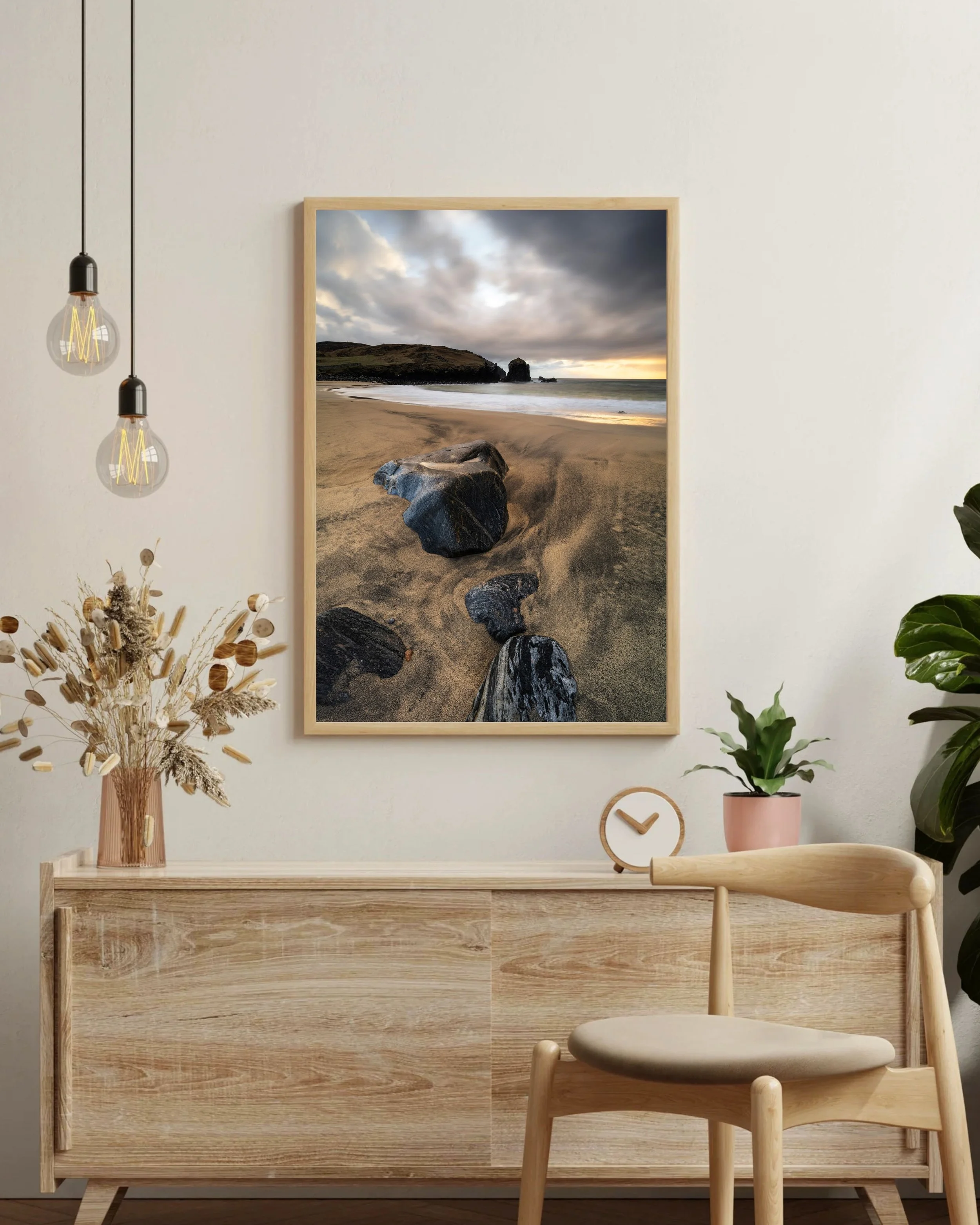 Framed print of “Dalbeg Beach” displayed on a wall, showing warm evening light across wet sand, carved tide patterns, and the cliffs that frame this small west‑coast beach on the Isle of Lewis.
