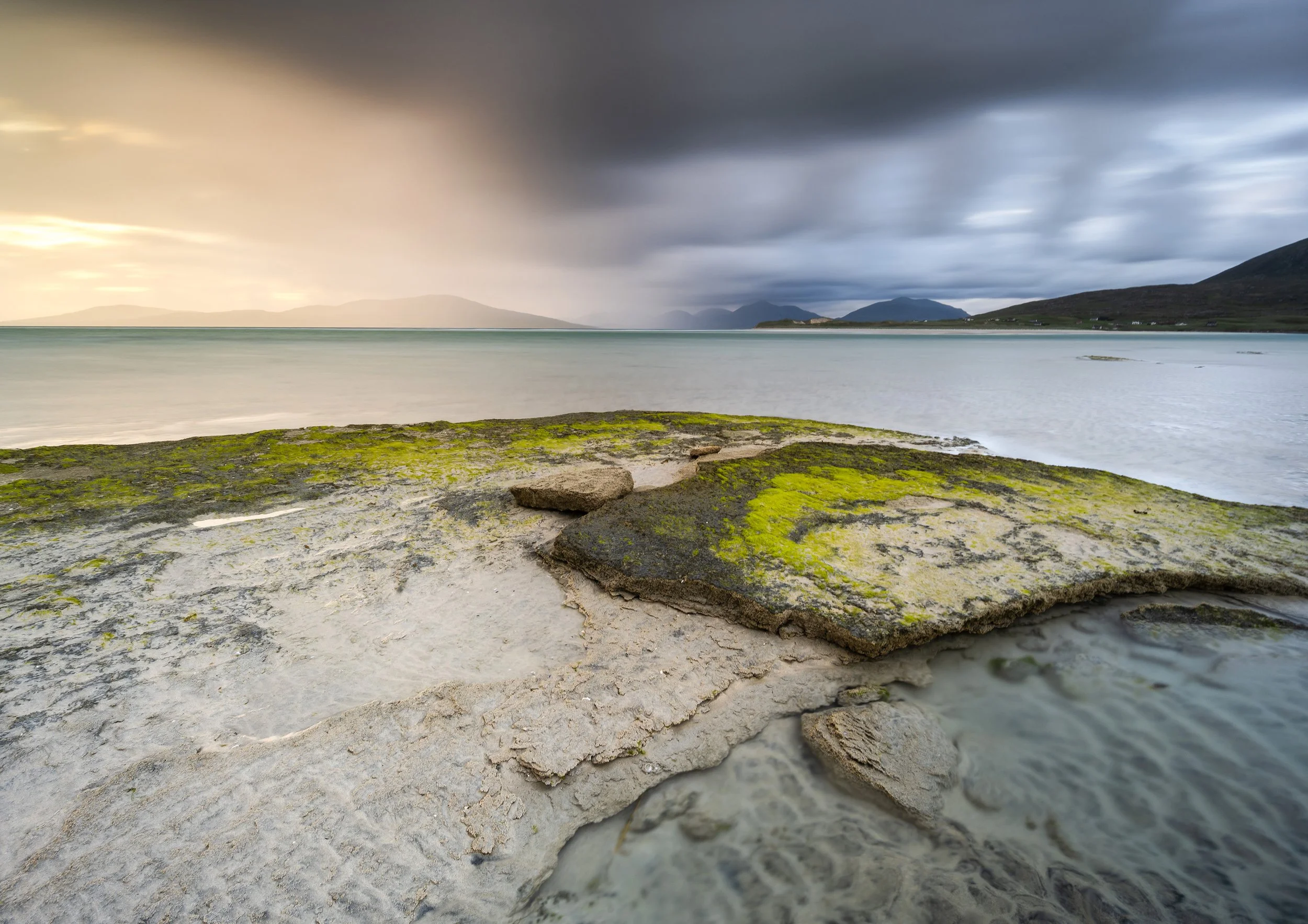 Seilebost Beach Isle of Harris Outer Hebrides seascape photography at sunset with moodt golden light long exposure seas and lots of atmosphere. Rocky rugged foreground makes for m=great photographic interest