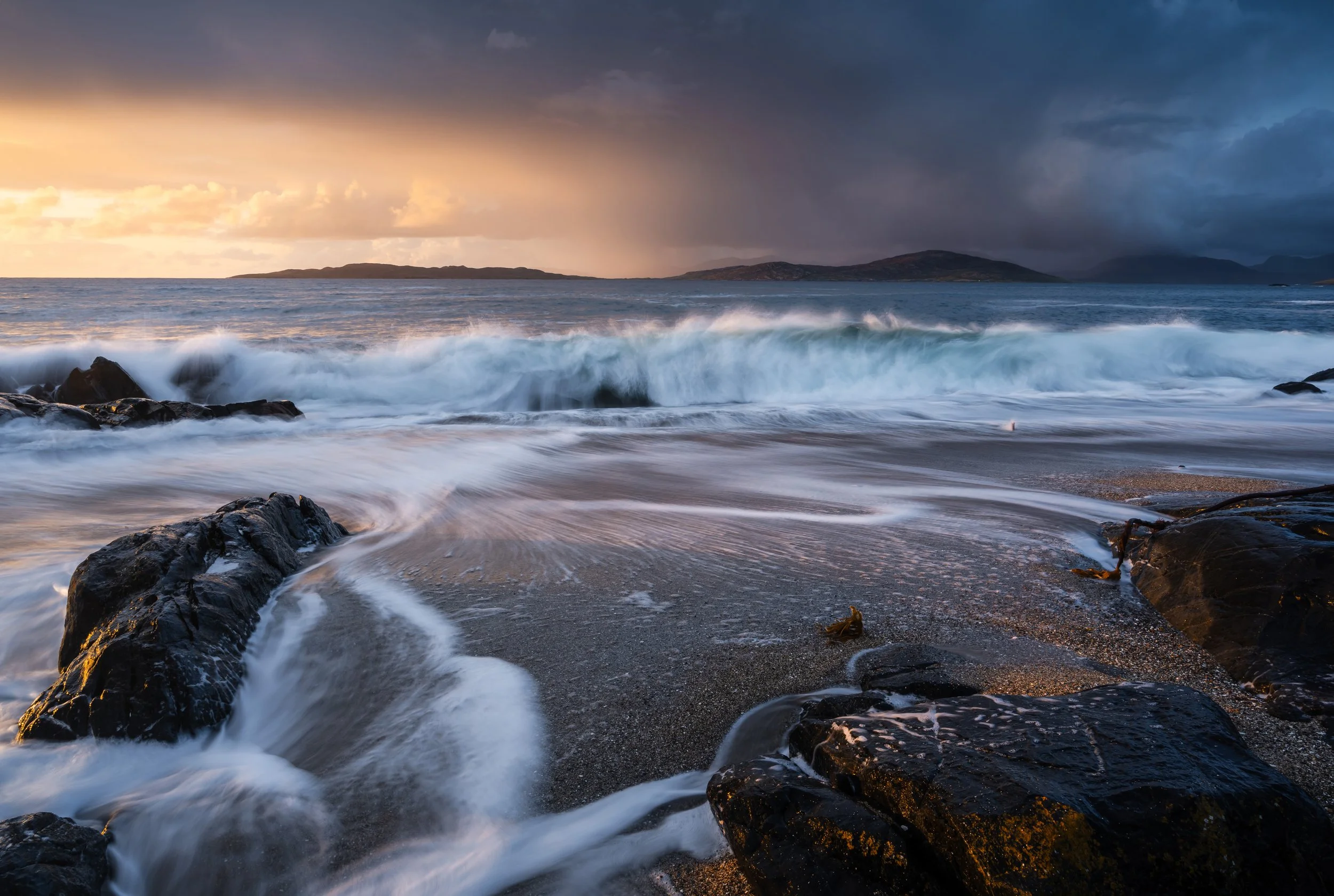 Small beach isle of harris long exposure sunset image of waves washing into shore 