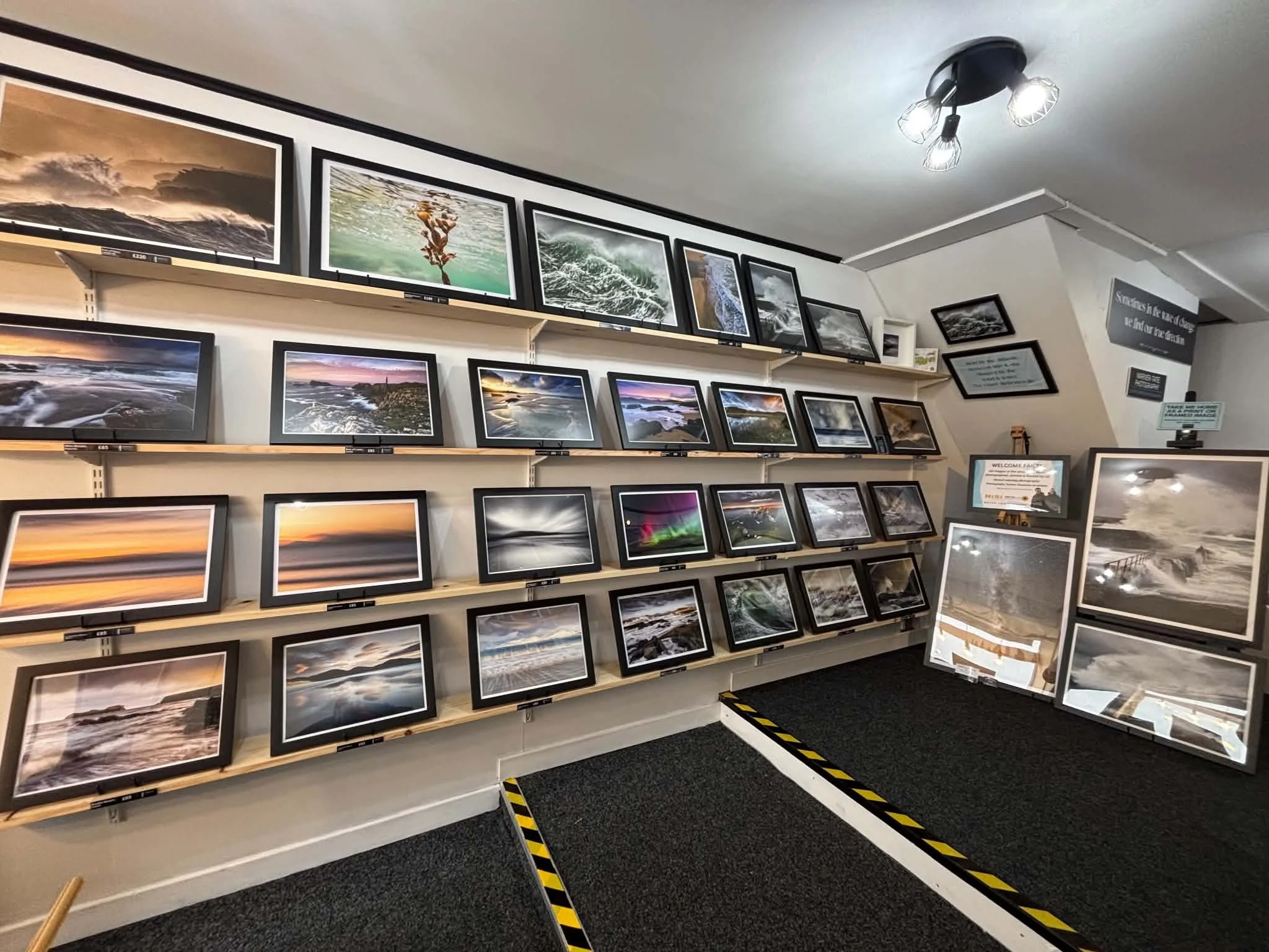 Interior of Warner‑Tate Photography Gallery in Stornoway, showing framed Hebridean prints on display.