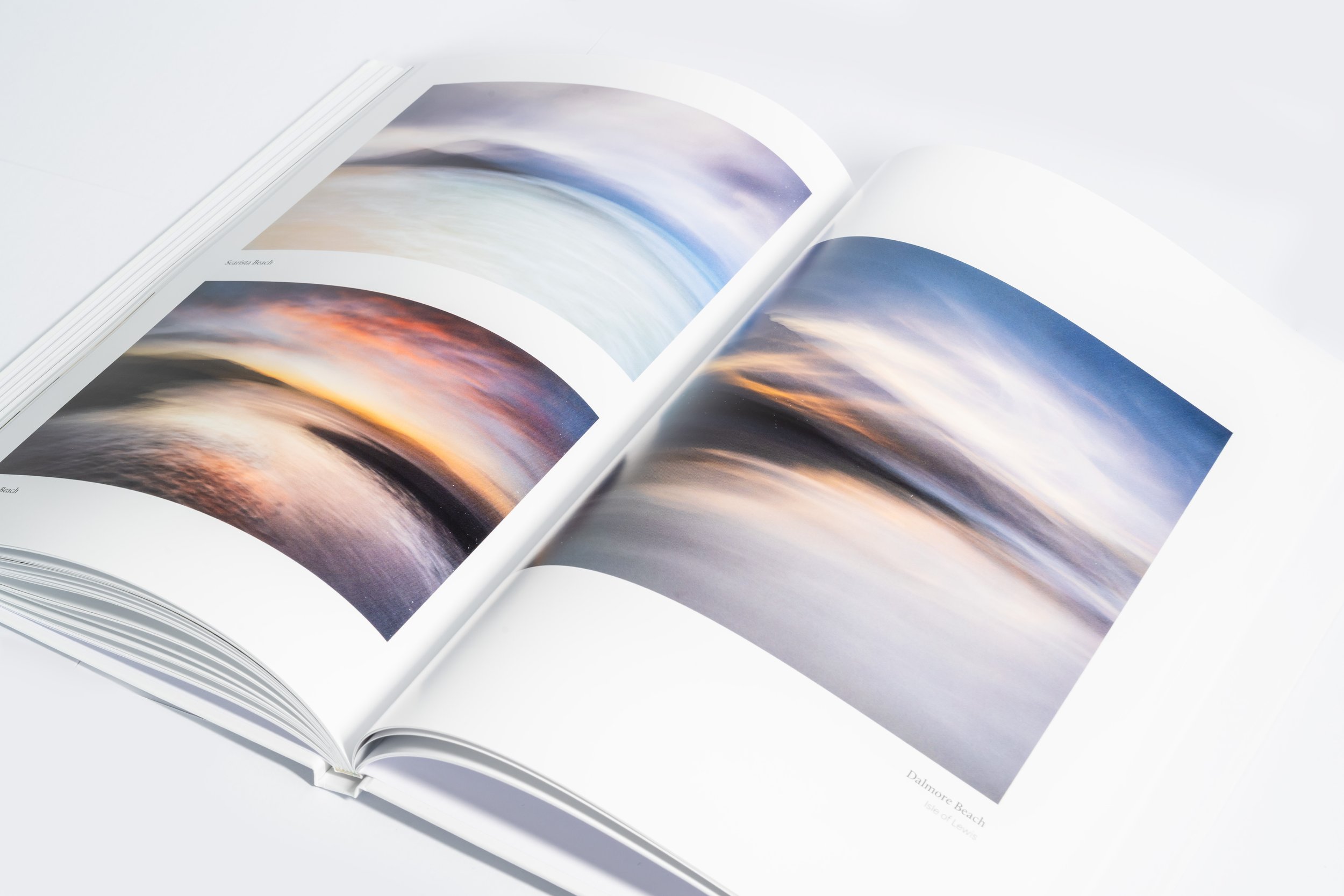 Inner page showing a Hebridean coastal scene from the Harris & Lewis photography book.