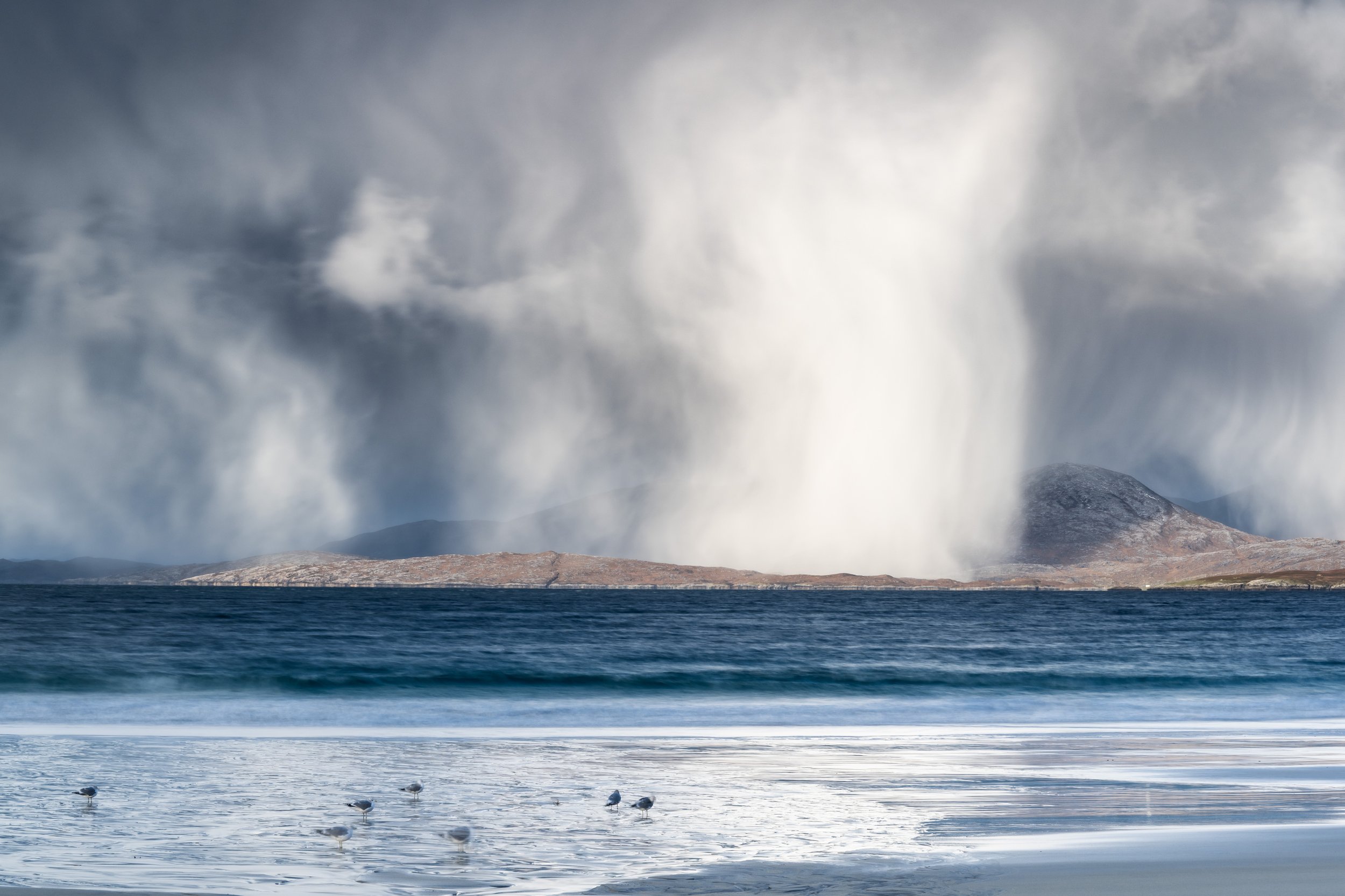 Luskentyre Beach Isle of Harris Outer Hebrides during winter with heavy snow showers passing through.
