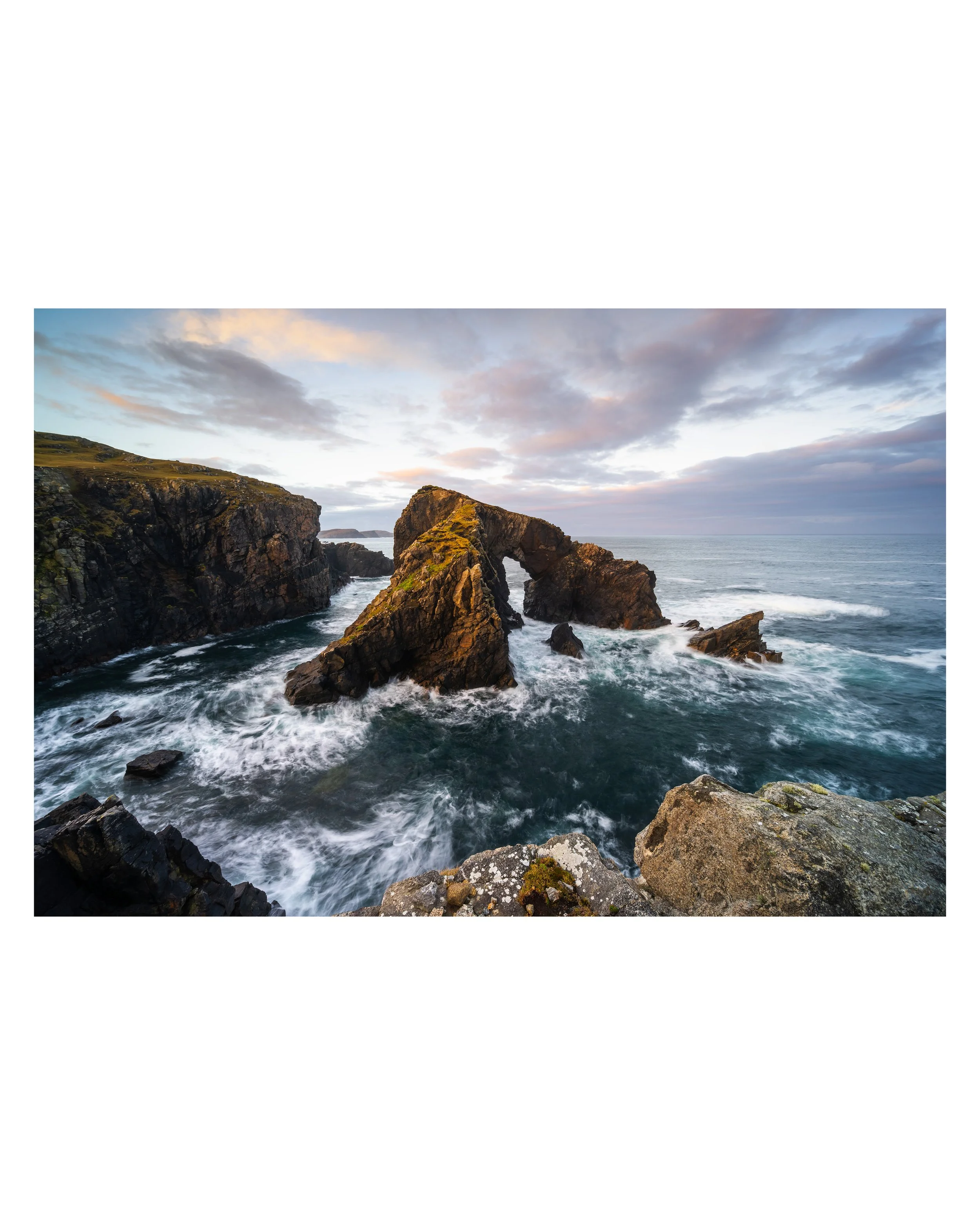 Fine‑art photograph of Stac a’ Phrìs sea arch with long‑exposure water and soft sunrise light on the west coast of the Isle of Lewis.