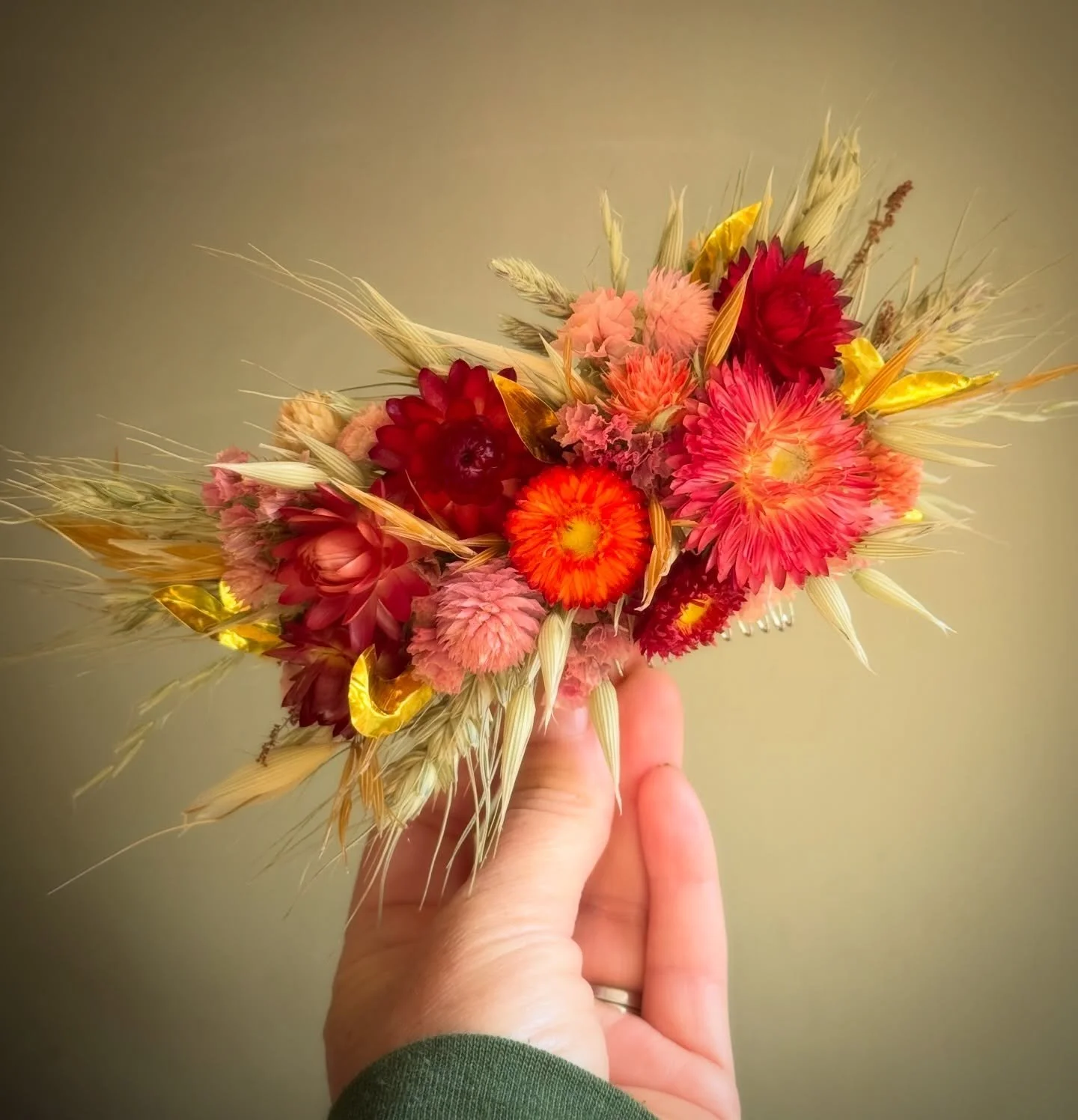 I loved the brief for this comb. I was made for the bride having a Scandi-Indian wedding! 
.
Flowers in reds, oranges, and pinks, plus some &lsquo;gold&rsquo; leaves cut from recycled foil complement the colours in the sari and bridesmaids&rsquo; dre