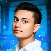 Saksham Magic youtube logo A young man with short dark hair and wearing a white shirt, standing outdoors at night with blue lighting in the background.