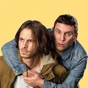 Goodall and Gallagher youtube logo Two men with long hair and casual denim jackets, one with a beard, posing against a yellow background.