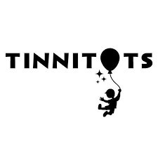 The word 'TINNITOTS' with an inflatable toy and a child hanging from the toy, surrounded by small stars or sparkles.