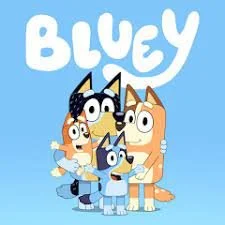 Cartoon characters from Bluey, including Bluey, her sister Bingo, and their parents, standing together against a blue background with the word 'Bluey' above them.