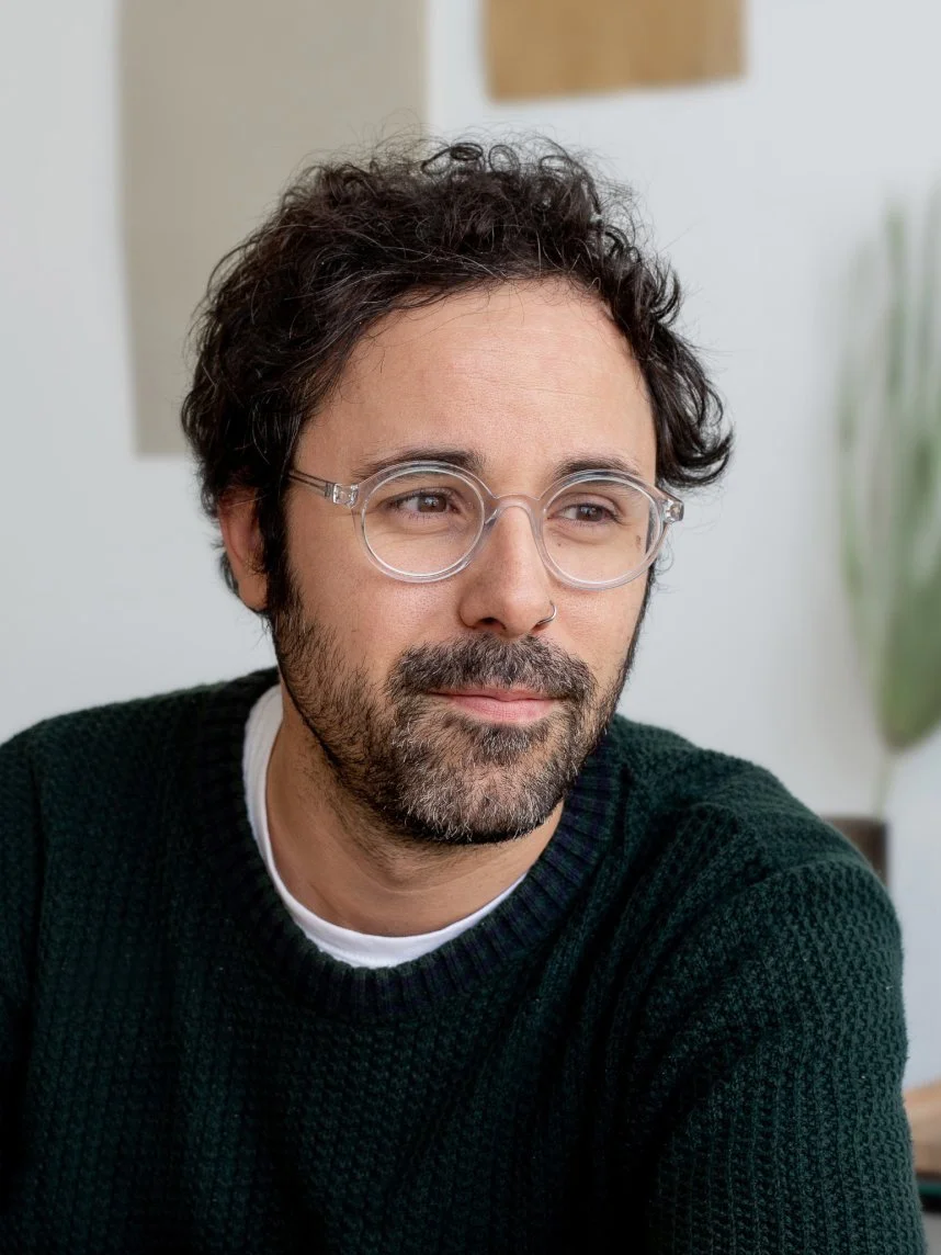 Uomo con barba, occhiali trasparenti e capelli ricci, olio di seno.
