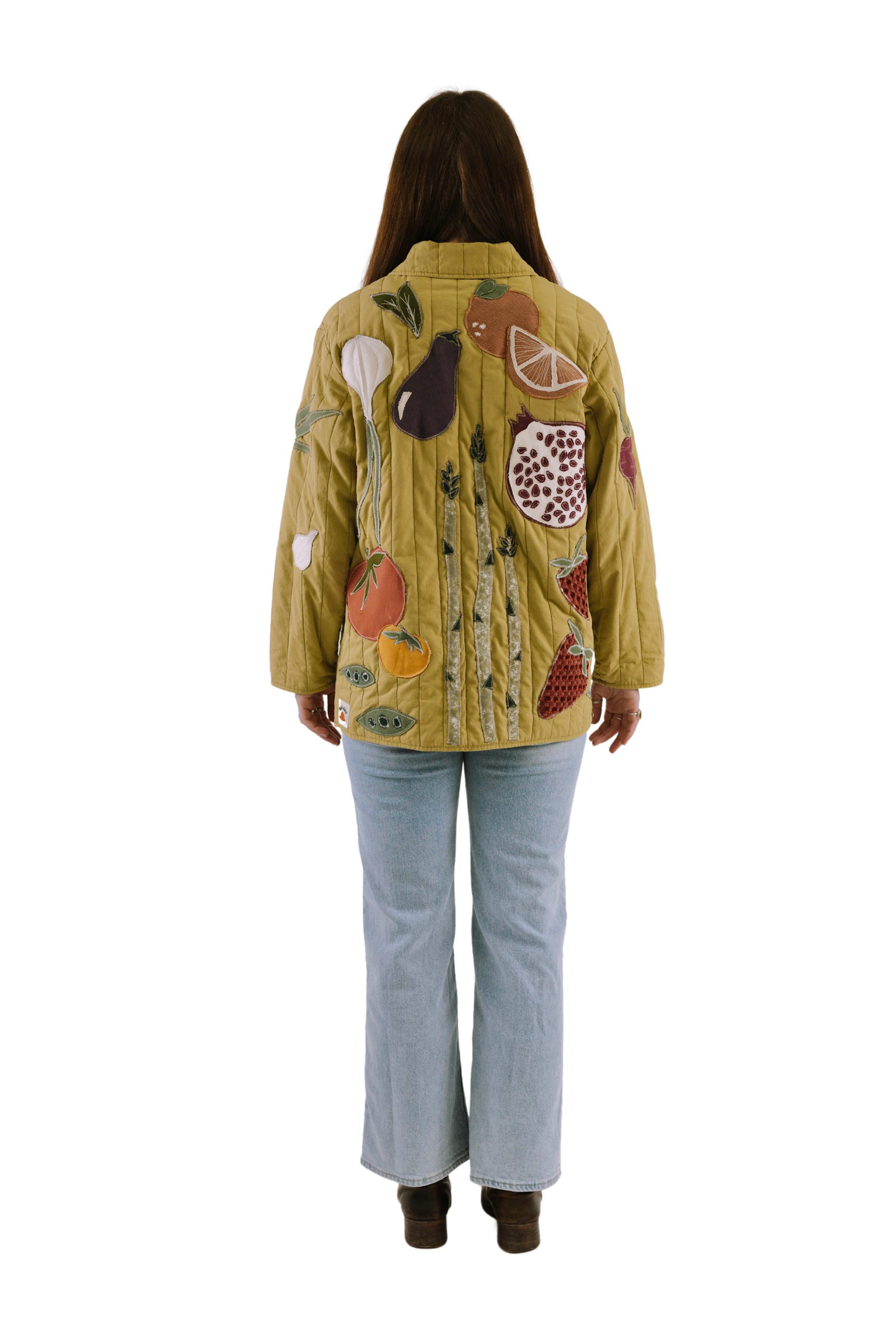 Back view of a custom quilted jacket showing the full patchwork design.