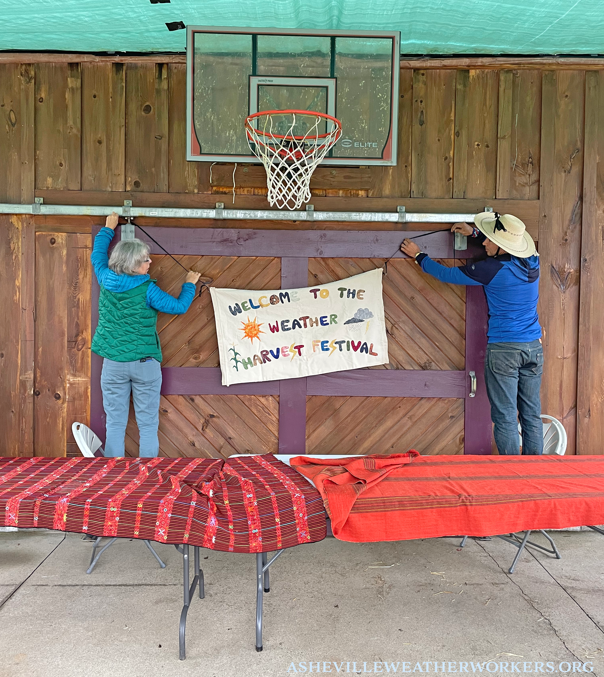 Amy and Adam hang the Welcome sign in the basketball court that we proceeded to transform into a ceremonial altar space for our Harvest Festival ceremony.