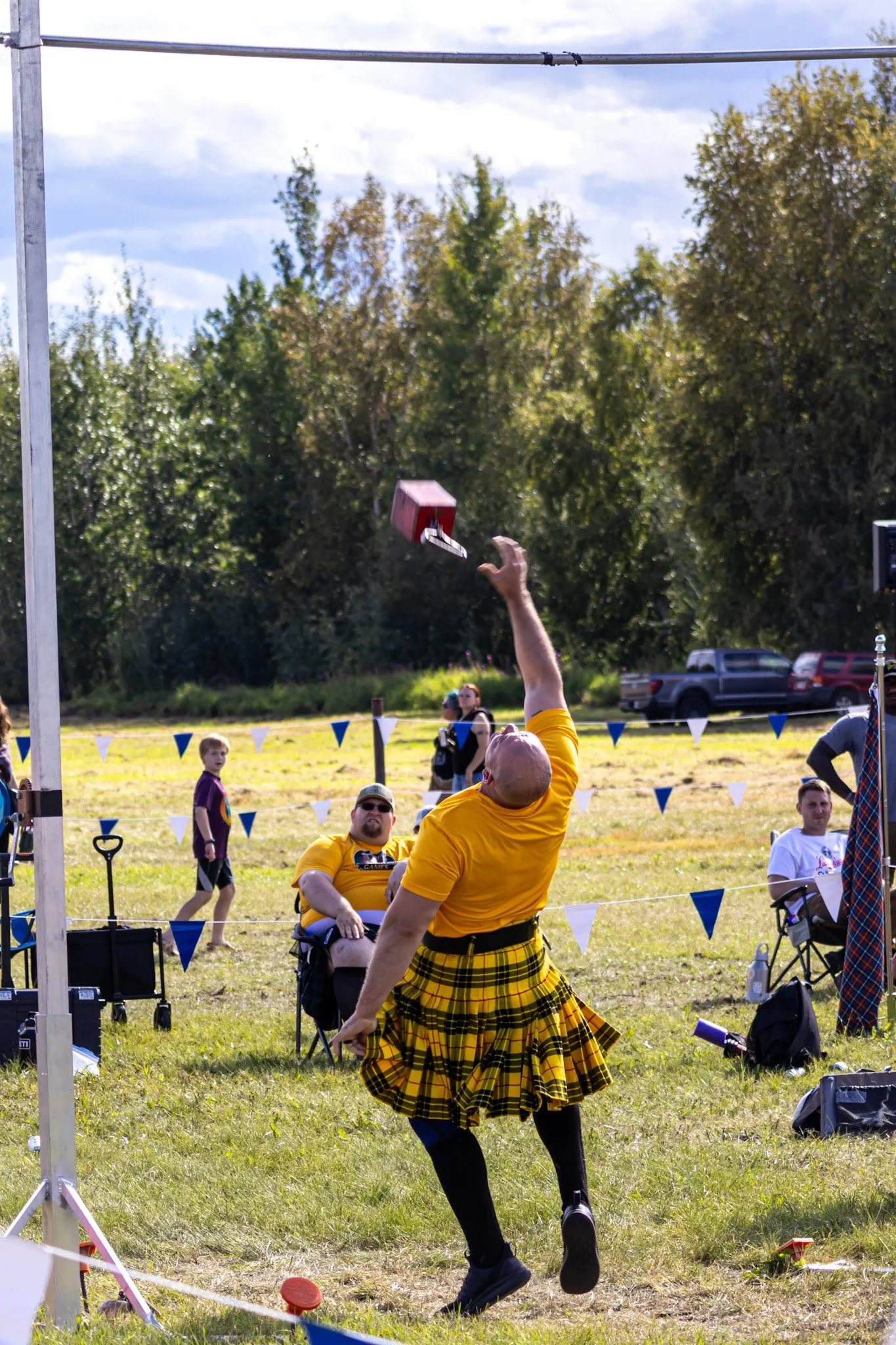 A wee bit of Scottish tradition on display as a participant attempts the Sheaf toss, a test of precision and strength.