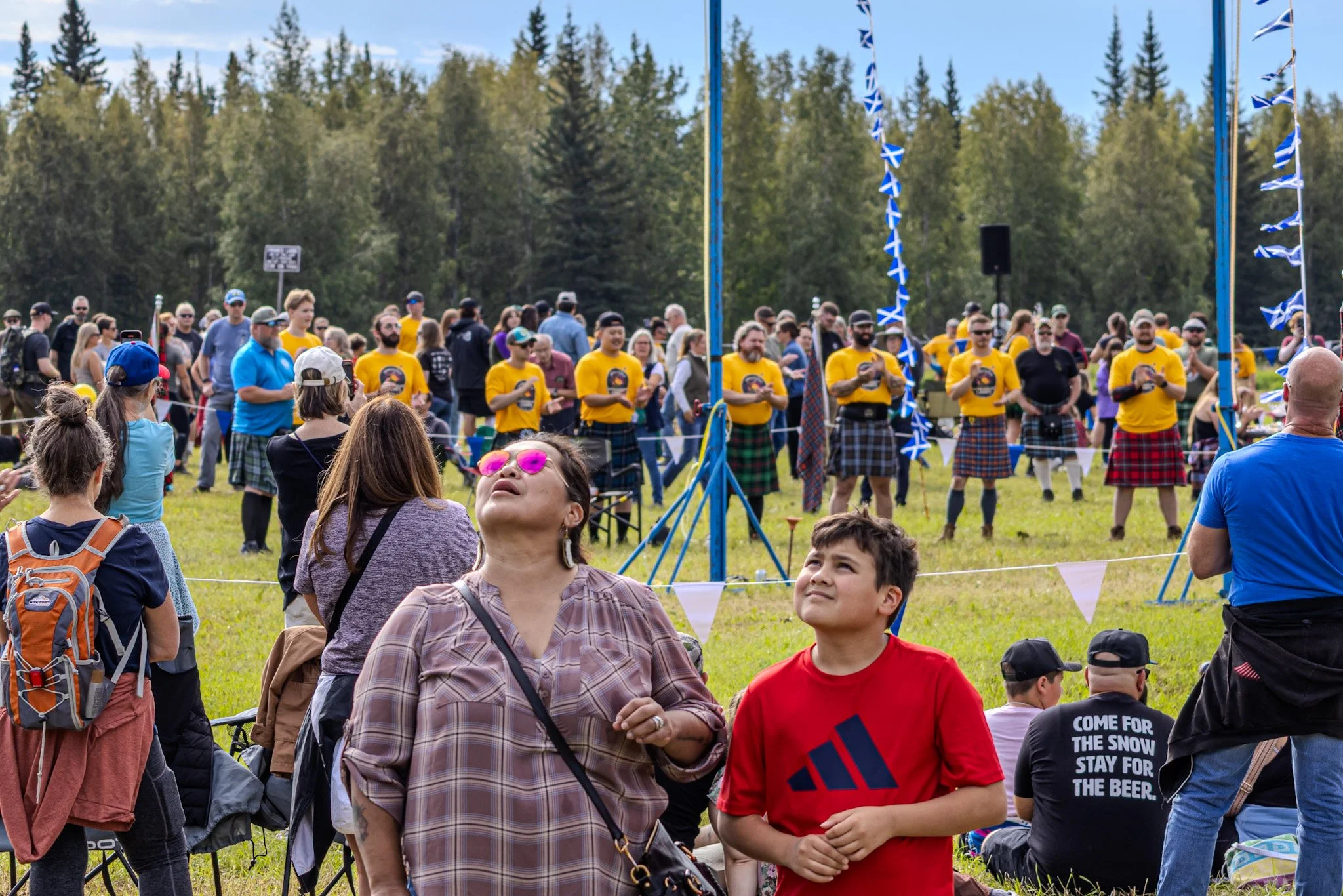 A mother and son caught up watching the clouds rather than the games happening behind them.