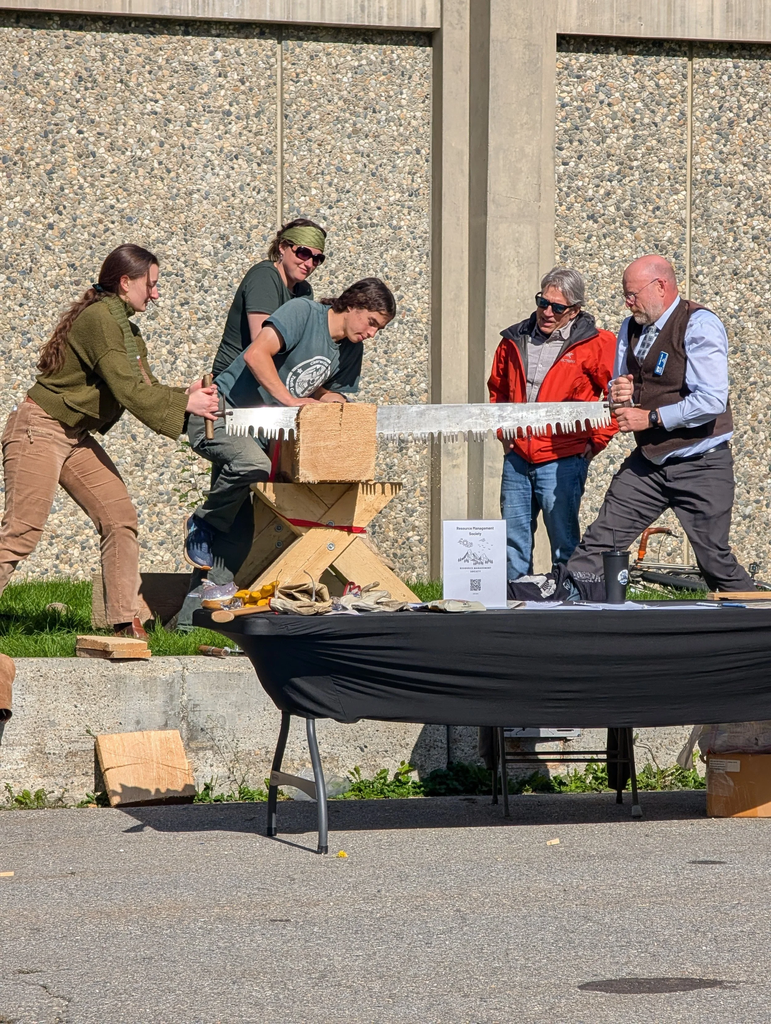 Attendees participate in woodsawing contest hosted by Resource Management Society in Constitution Park.