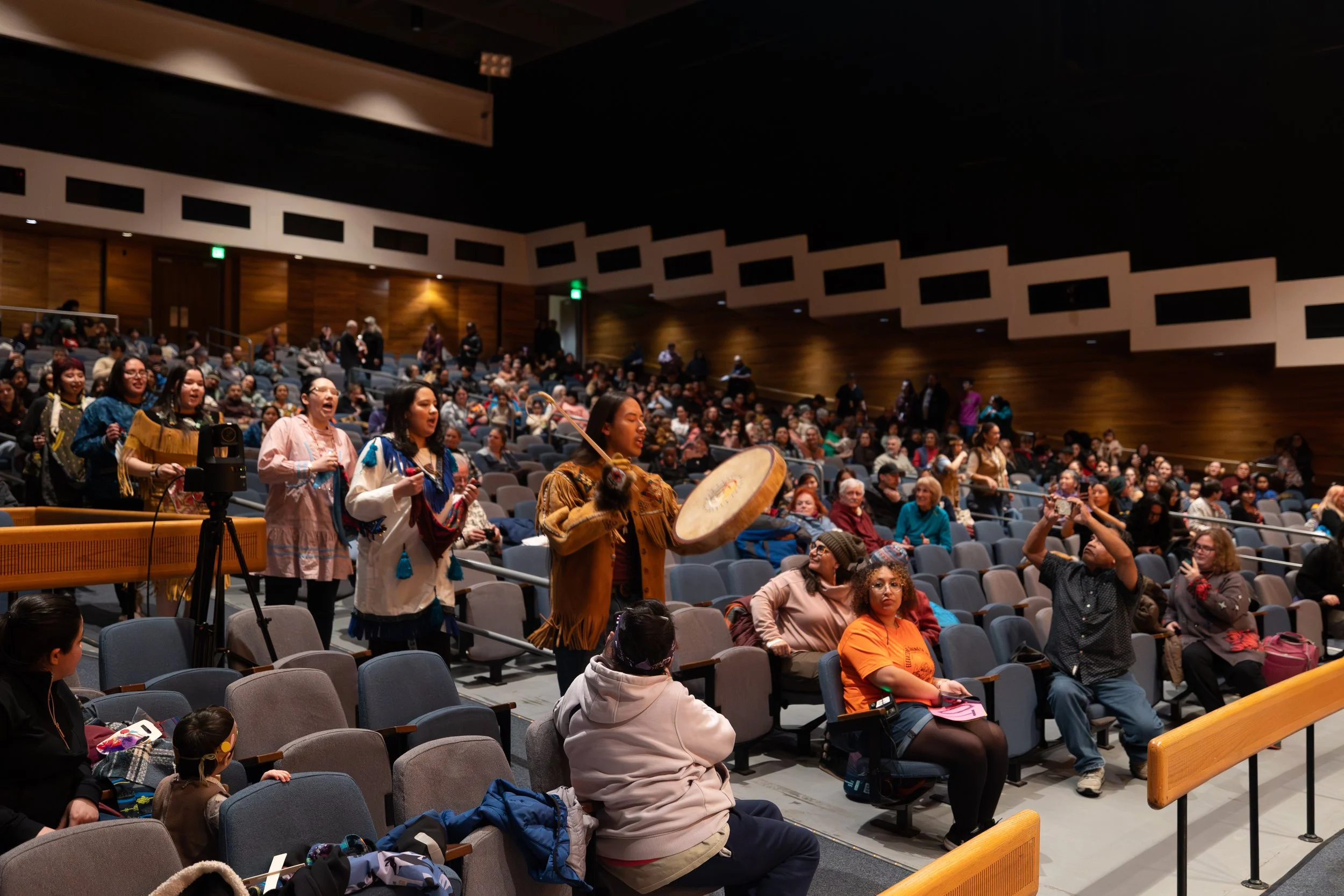 Photo by Elvie Underwood - The Troth Yeddha' Dance Group advances towards the stage, while singing an opening song during the first night of the 2026 Festival of Native Arts.
